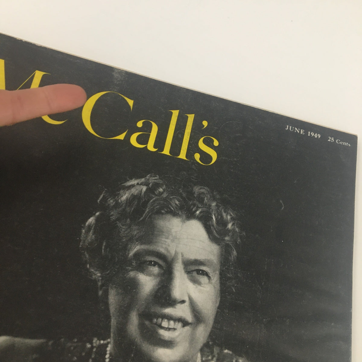 Close-up of the cover of McCall's Magazine June 1949 highlighting the title and a smiling woman, emphasizing the magazine's retro appeal.