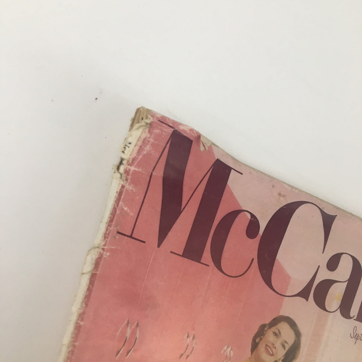 Close-up of the top corner of McCall's Magazine September 1955, highlighting vintage wear and the iconic branding of the magazine.