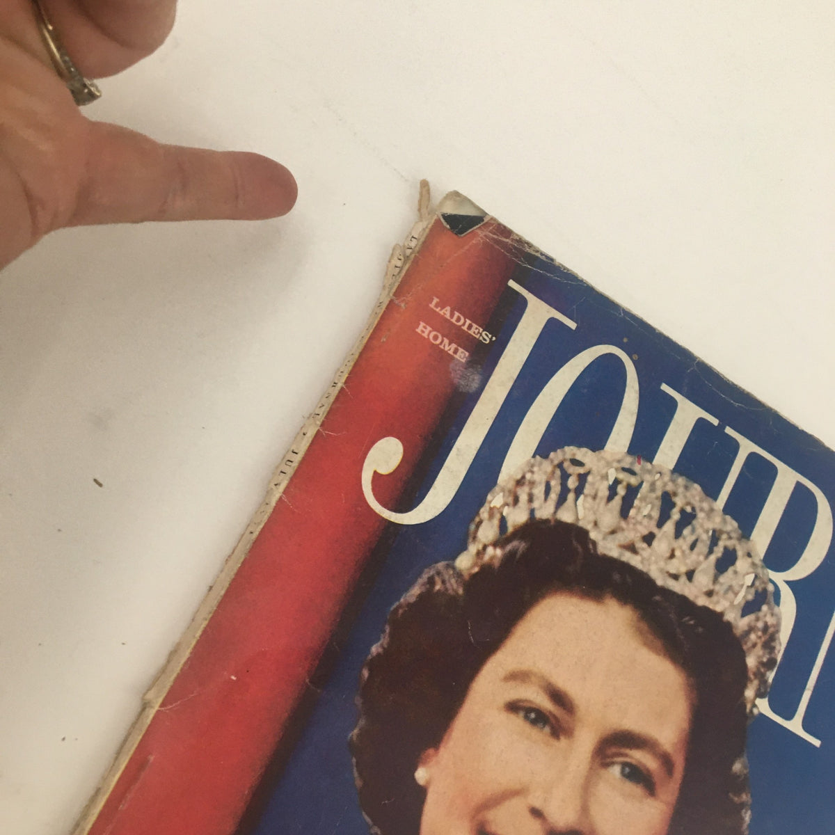 Close-up of the Ladies' Home Journal Magazine July 1961 cover showing Queen Elizabeth II, highlighting the wear and age of the vintage publication.