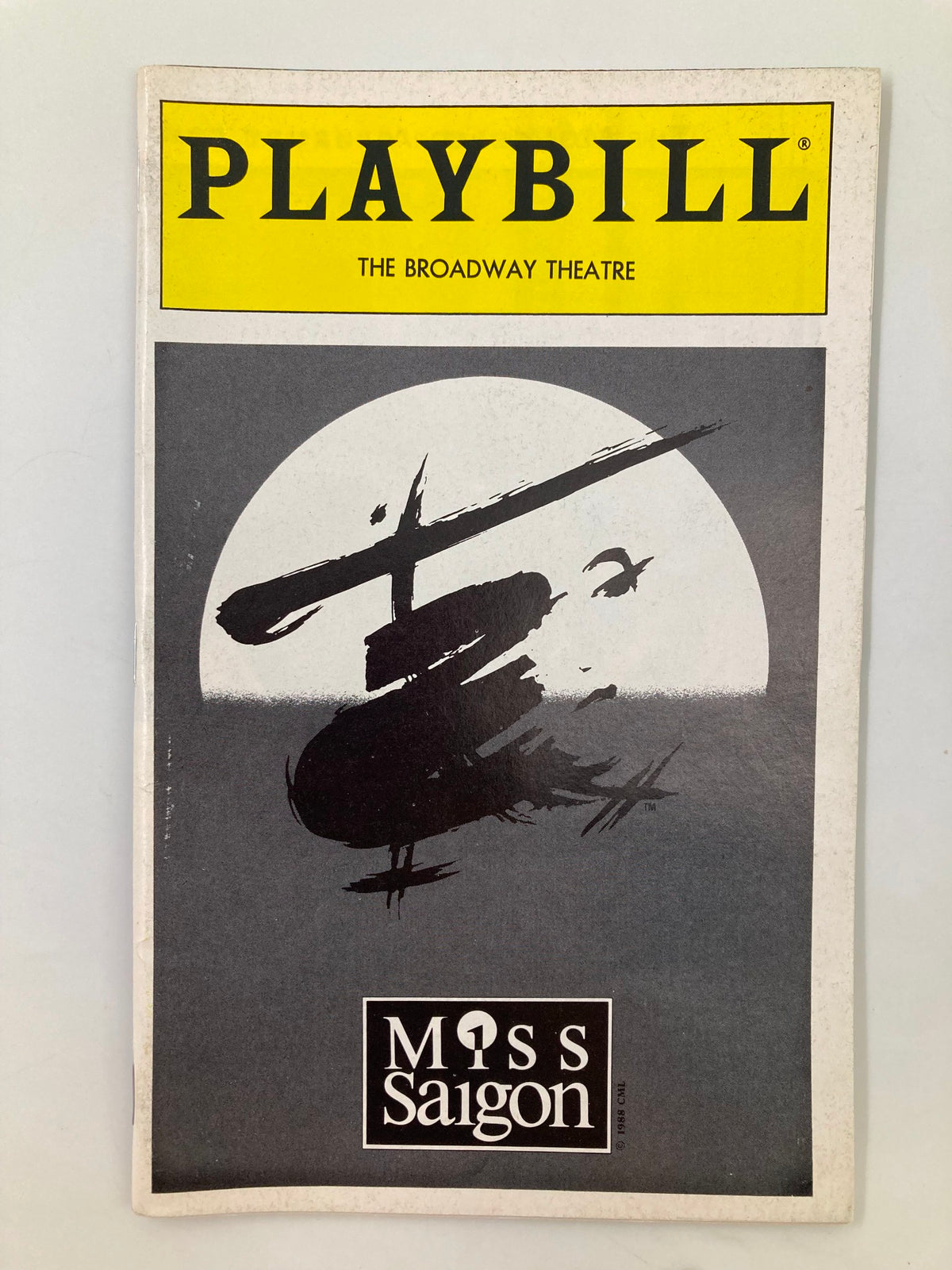 1995 Playbill from the Broadway Theatre for Miss Saigon featuring a striking helicopter illustration on the cover.