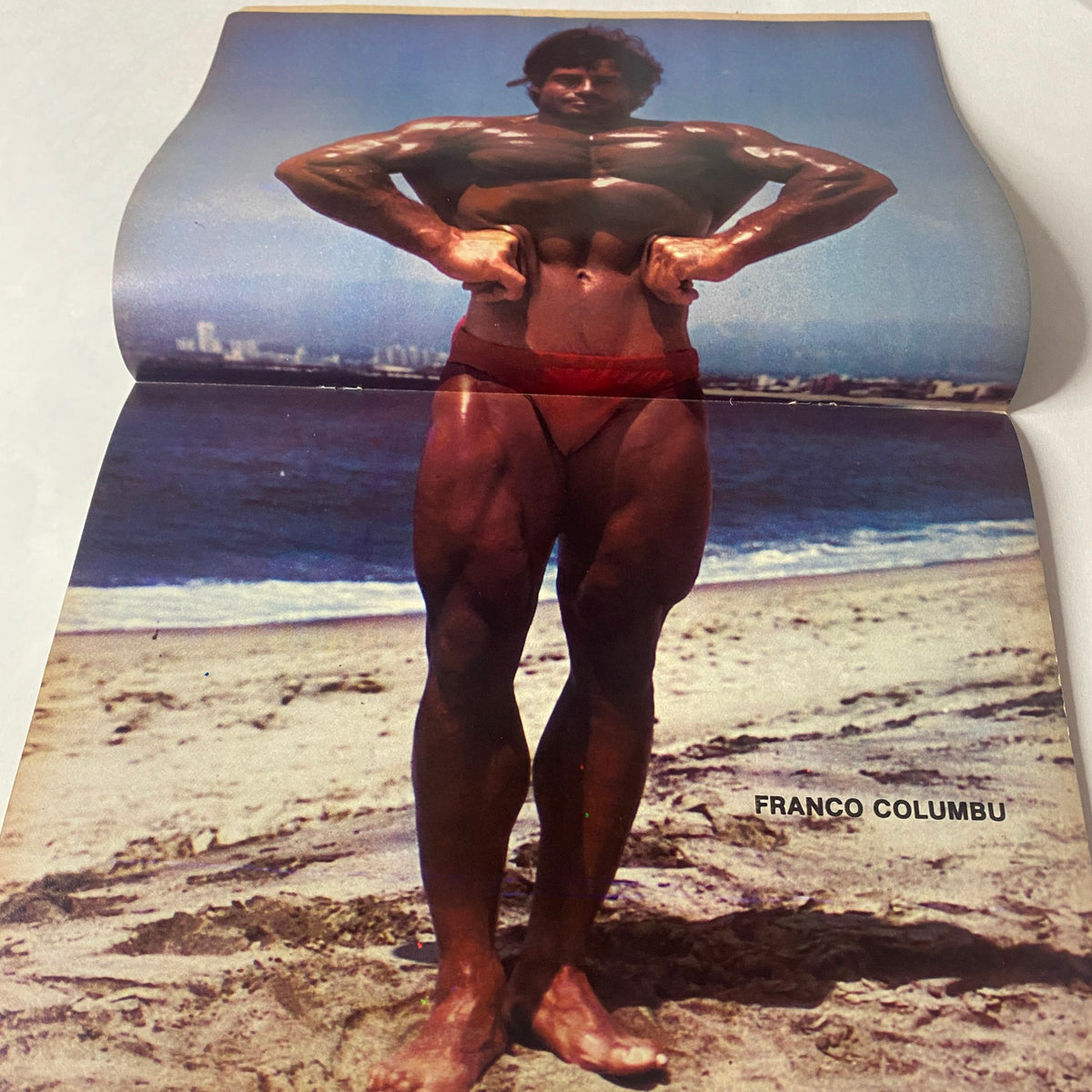 Muscle Up Magazine October 1979 Vol 1 No 1 Franco Columbu presented in a beach setting, highlighting his physique in a striking centerfold photograph.