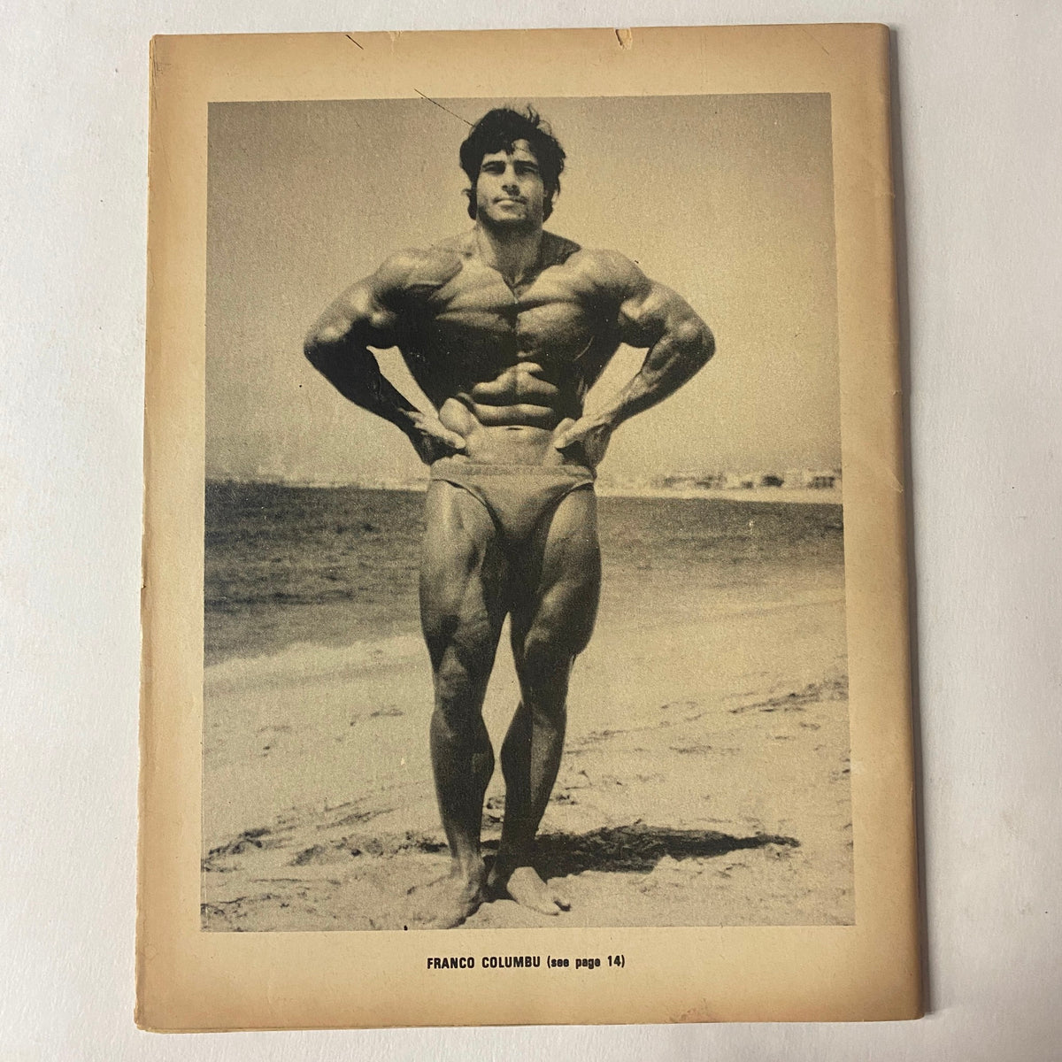 Muscle Up Magazine October 1979 Vol 1 No 1 Franco Columbu photographed on the beach, emphasizing his impressive muscular development.
