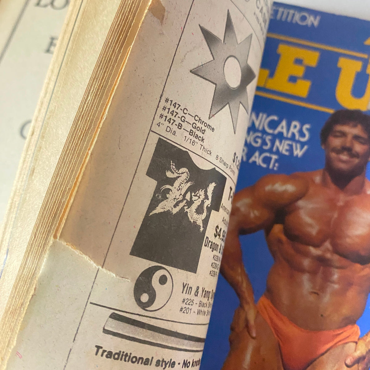 Interior page of Muscle Up Magazine February 1980 showing an advertisement alongside a vibrant centerfold image.