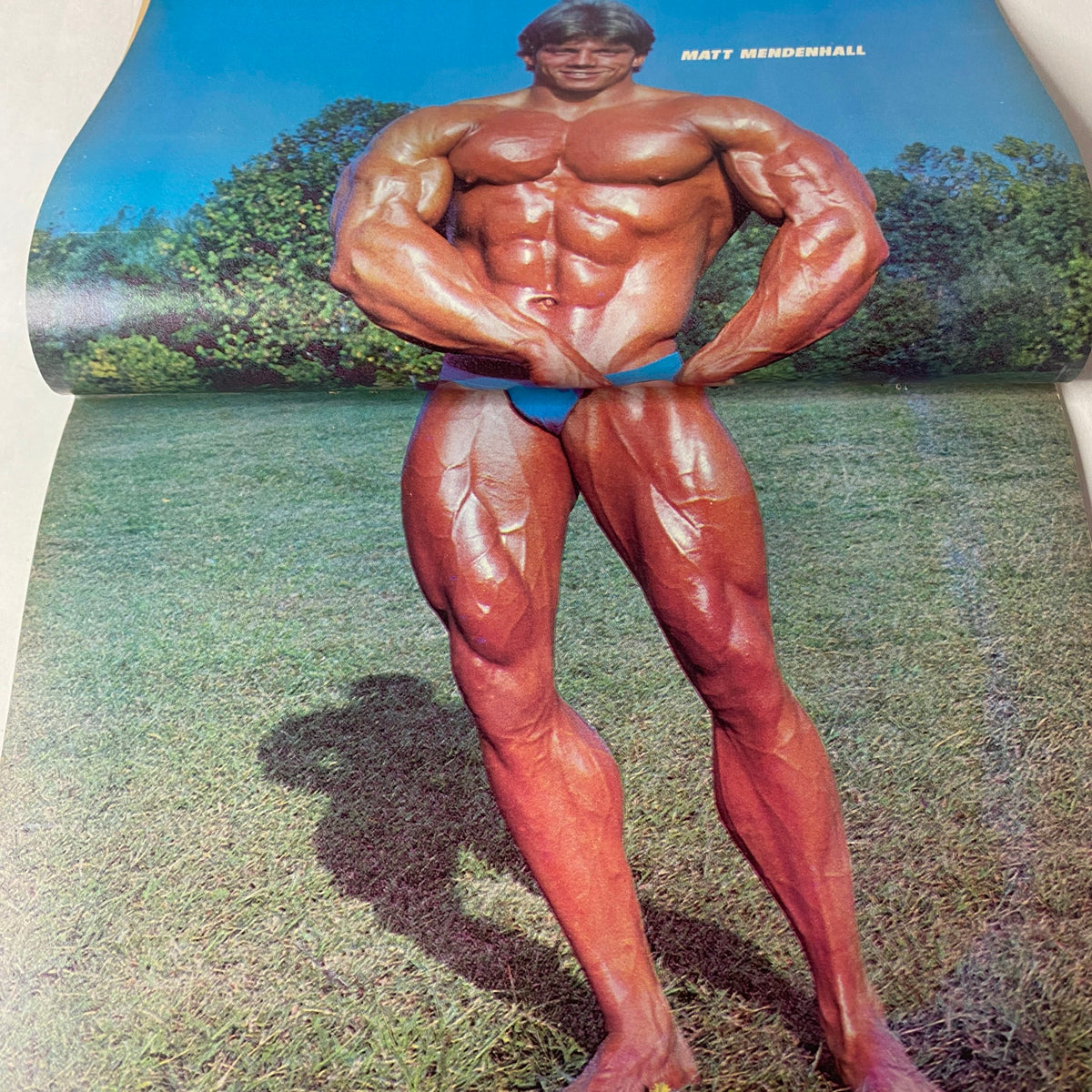 Centerfold of Muscle Up Magazine April 1983 Vol 5 No. 22 featuring Matt Mendenhall in a dramatic bodybuilding pose outdoors.
