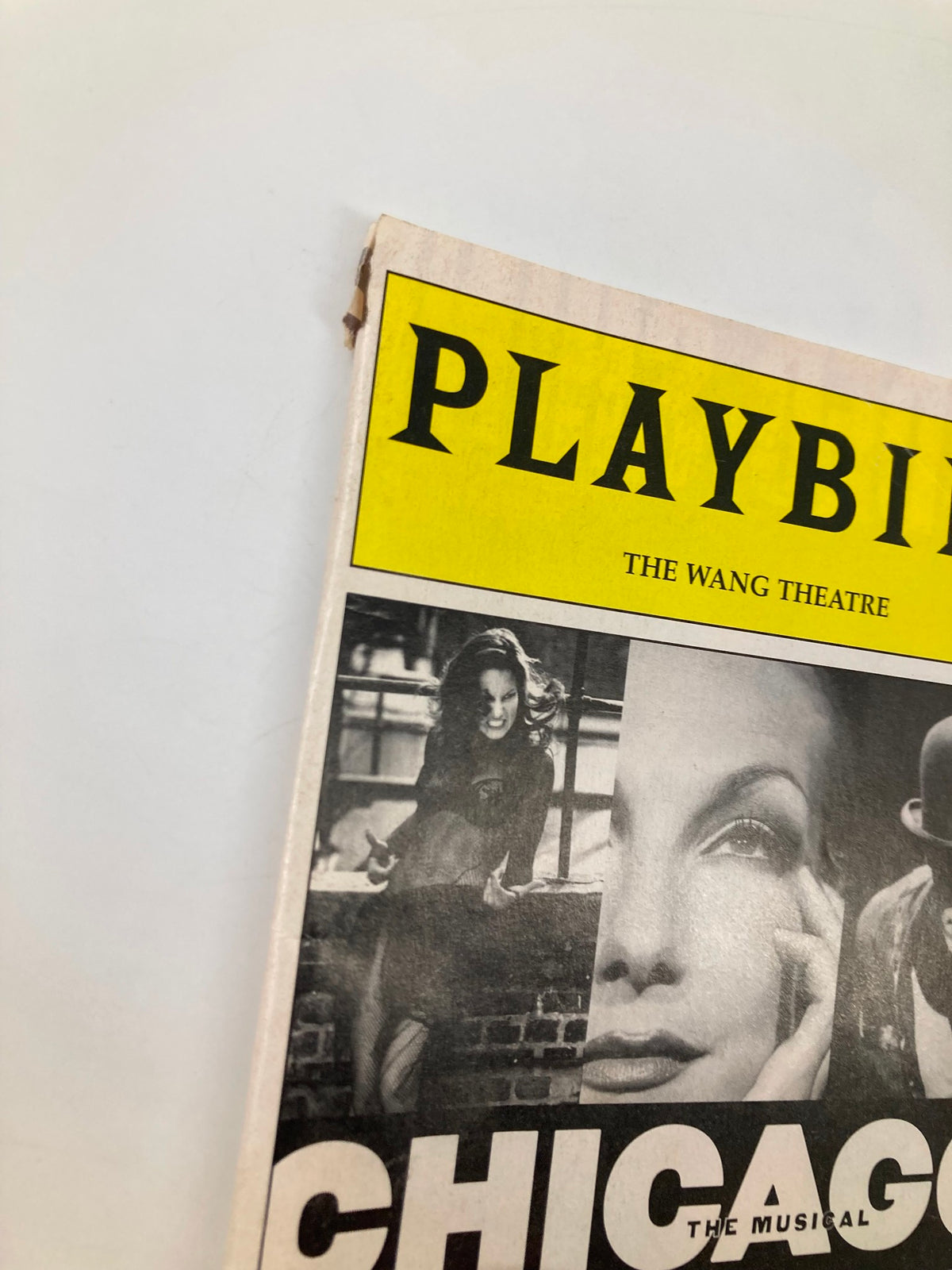 Close-up of the top corner of the 2003 Playbill for Chicago at the Wang Theatre, showing minor wear and the iconic title logo.