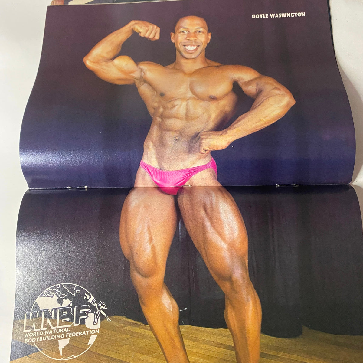 Centerfold image of Doyle Washington from Natural Physique Magazine September 1990, displaying his muscular physique and posing style as a competitor in the World Natural Bodybuilding Federation.