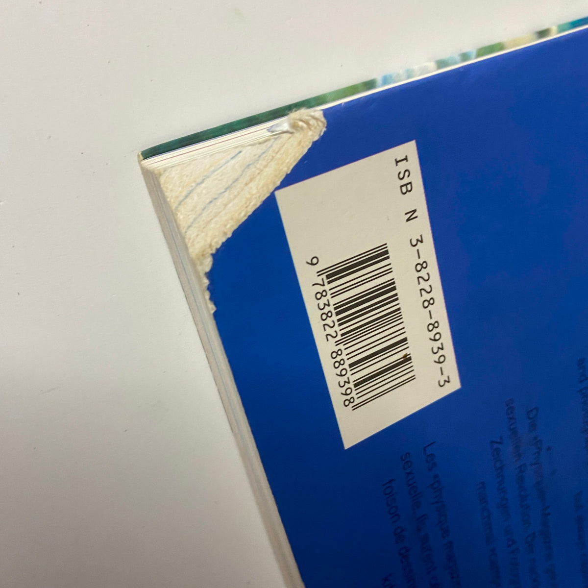 Close-up of the spine of 'Beefcake: The Muscle Magazines of America, 1950–1970' by F. Valentine Hooven III, showcasing the ISBN barcode and book binding details.