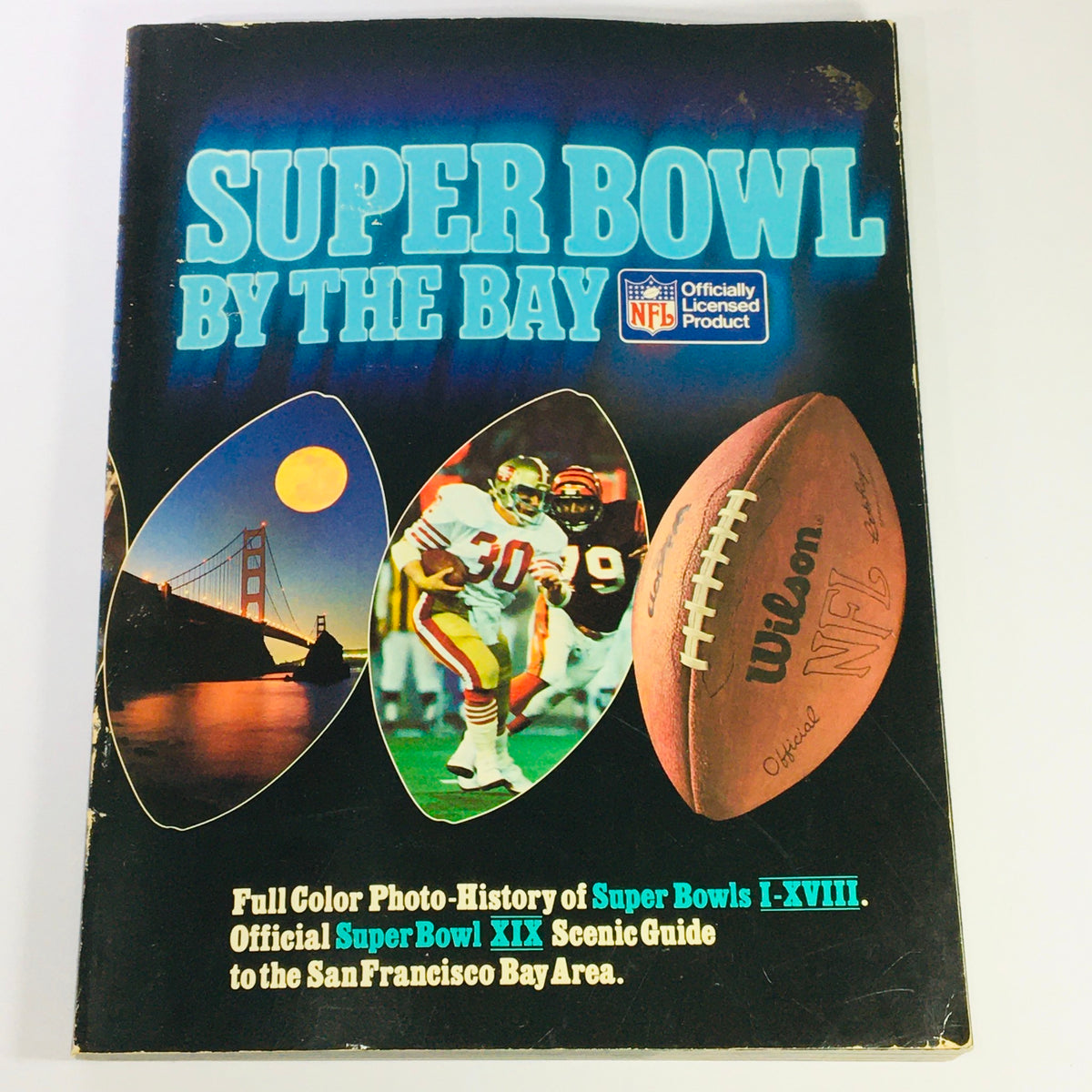 VTG 1984 Official Super Bowl XIX Scenic Guide to San Francisco Bay showcasing the cover featuring vibrant images of the Golden Gate Bridge, NFL players, and a football.