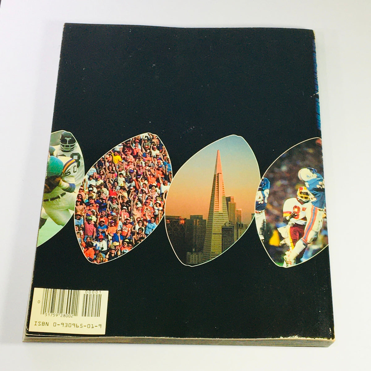 Back cover of the VTG 1984 Official Super Bowl XIX Scenic Guide to San Francisco Bay, displaying images of sports fans and the iconic San Francisco skyline, emphasizing its historic significance.