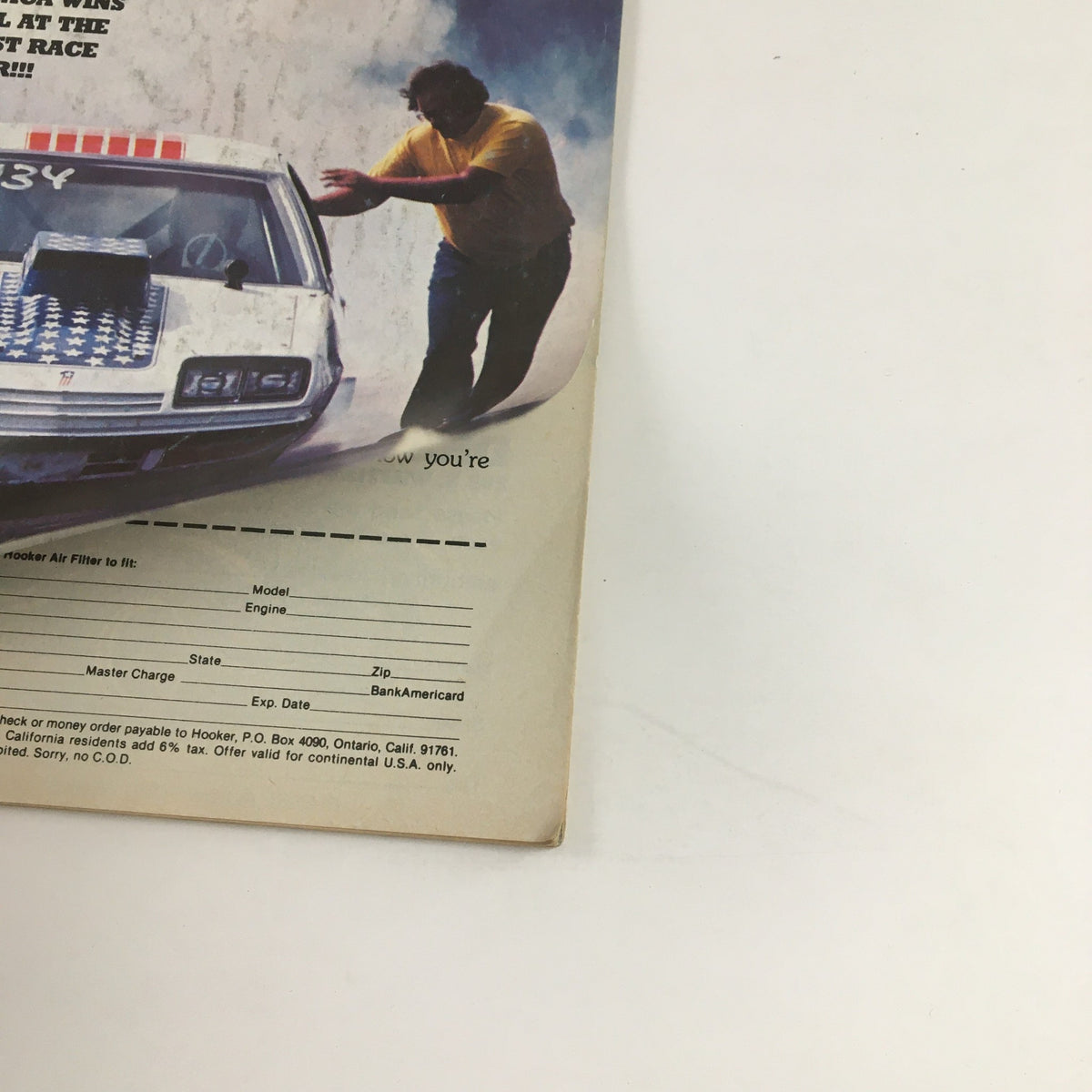 Back cover of Super Stock Magazine December 1977 featuring a classic racing car and a man inspecting it, related to the story of Bill Jenkins' Monza burning to the ground.