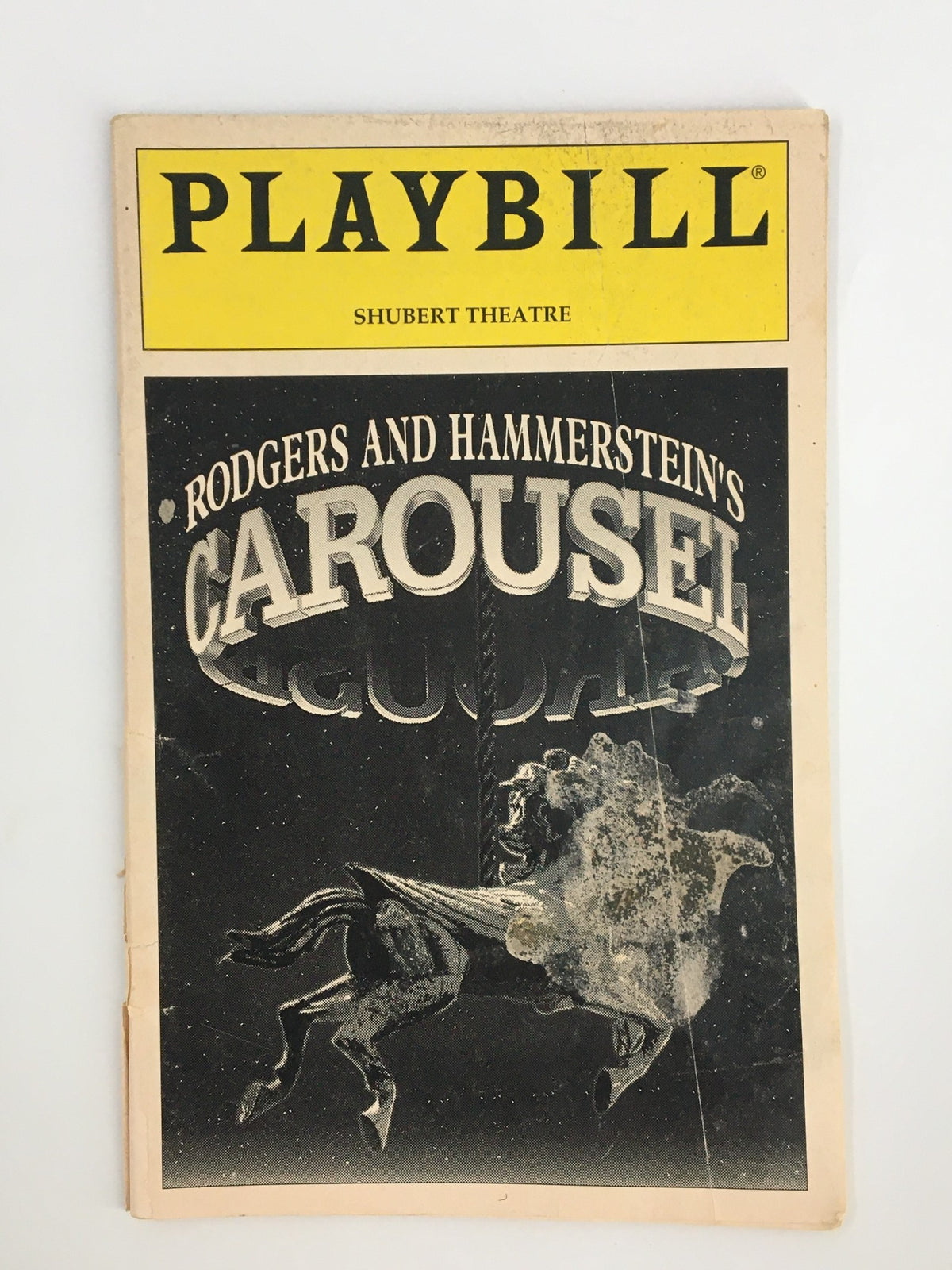 Front cover of the 1996 Playbill for Rodgers and Hammerstein's Carousel at the Shubert Theatre, showcasing a vintage design featuring a horse and carousel detail.