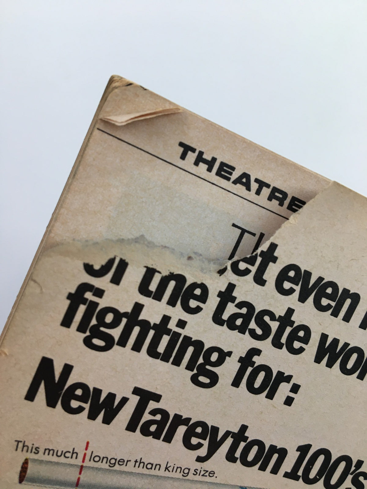 Corner detail of the 1967 Playbill - Don't Drink The Water showing wear and edge damage.
