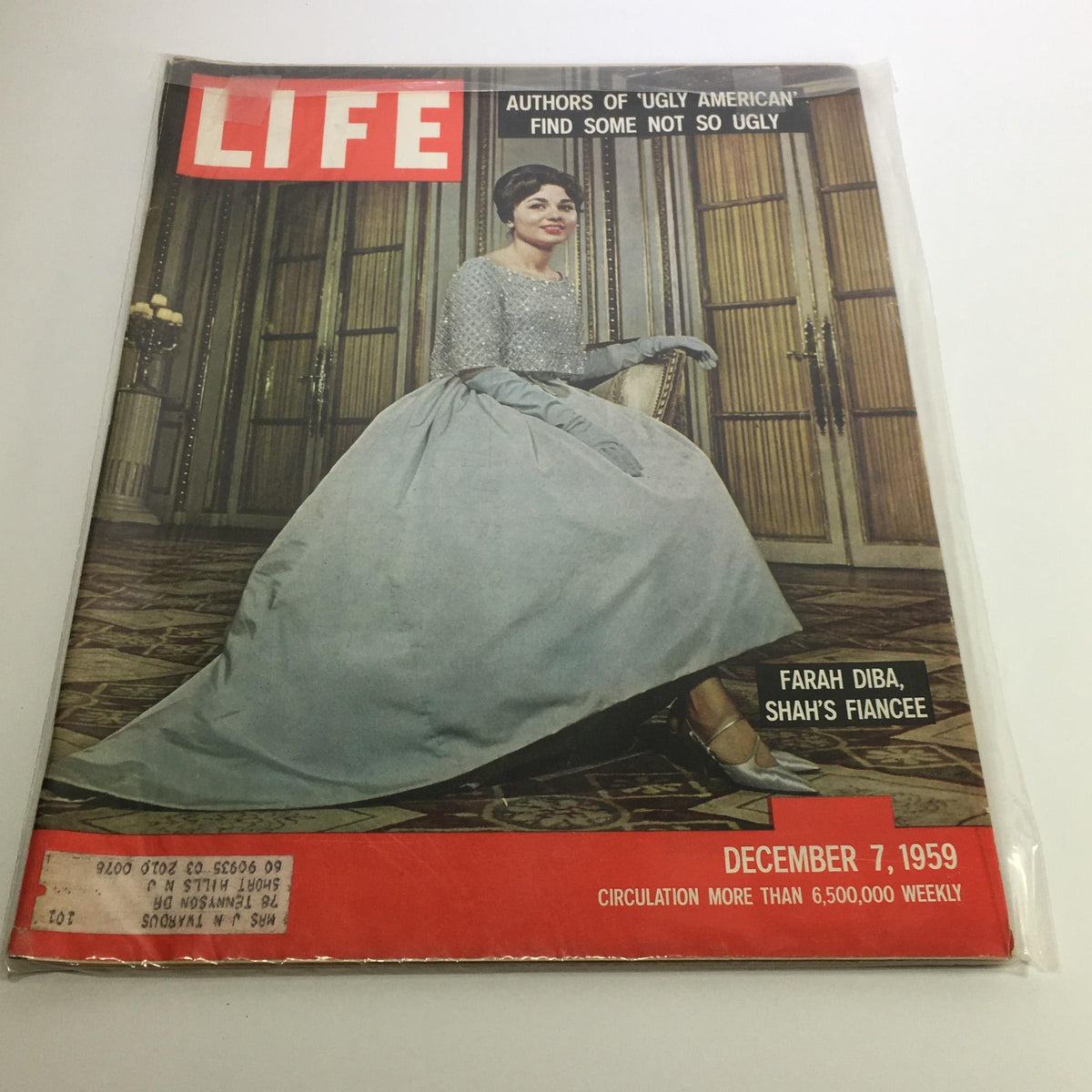 Life Magazine cover from December 7, 1959, featuring the title 'Authors of 'Ugly American' Find Some Not Ugly.' The image showcases a woman in an elegant dress, identified as Farah Diba, seated in a luxurious setting. This vintage magazine highlights themes of cultural identity in the late 1950s.