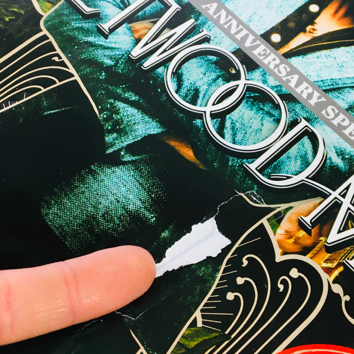 Close-up of Classic Rock Magazine November 2017 #242 showing minor damage with a small rip, highlighting its age for collectors.