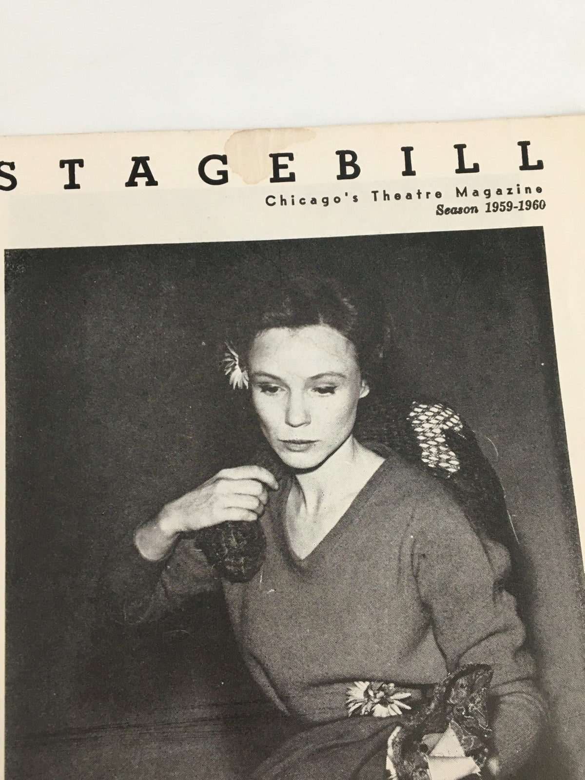 Close-up view of the 1960 Stagebill from Goodman Memorial Theatre featuring Frances Hyland in The Good Woman of Setzuan, highlighting the program's detailed cover design.