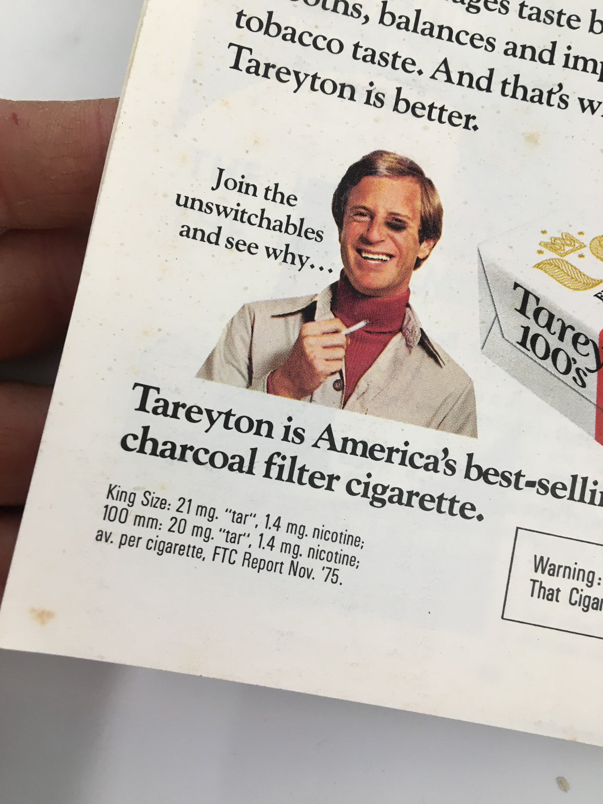 Advertisement for Tareyton cigarettes from the 1976 Stagebill, featuring a man promoting the charcoal filter cigarette with a thumbs up and product details.
