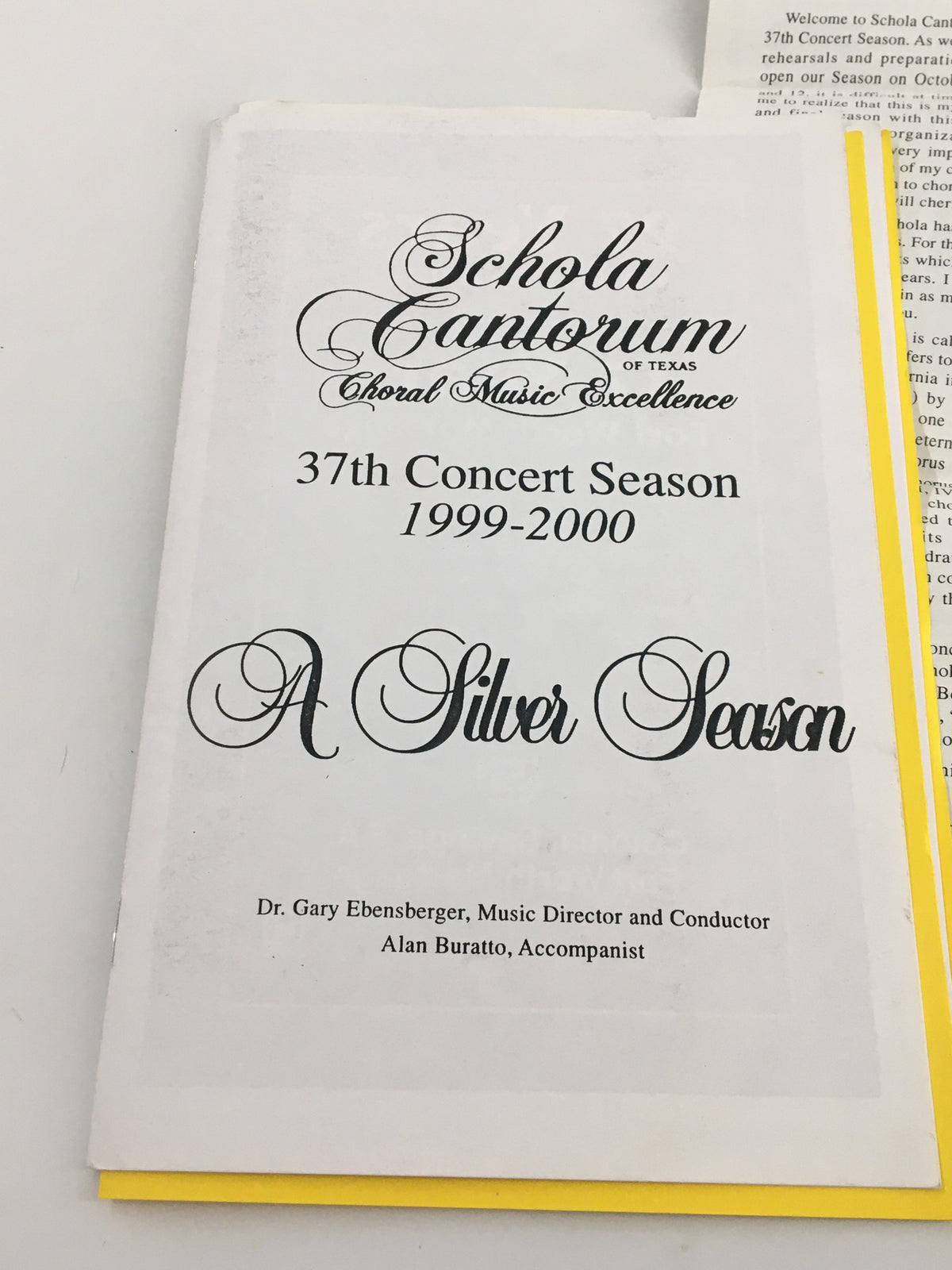 Close-up of the 1999 Schola Cantorum Choral Music Excellence A Silver Season 1999-2000 program titled 'A Silver Season' with notable names of the director and accompanist.