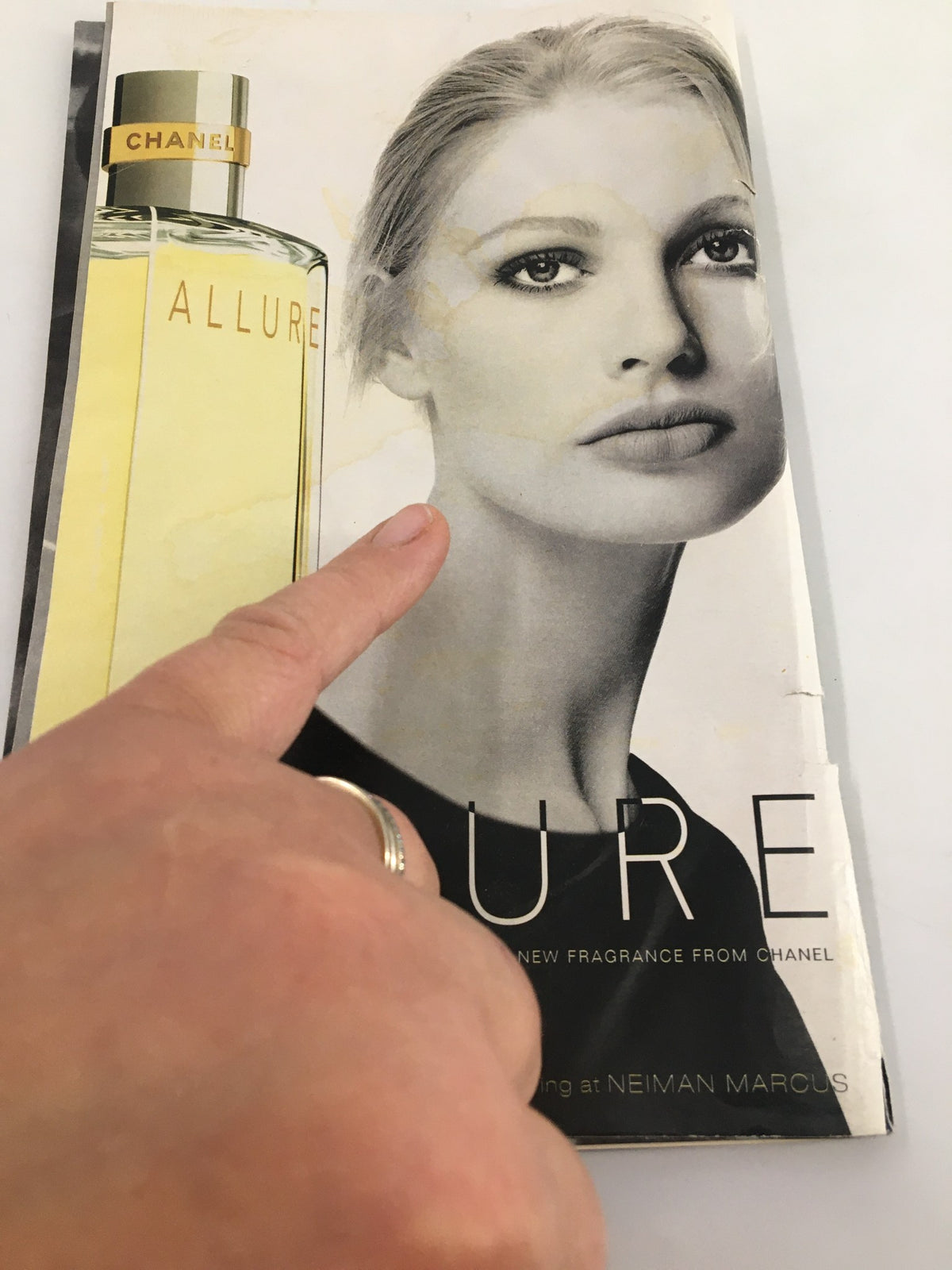 Advertisement image from the 1997 Stagebill for the Dallas Symphony Orchestra, showcasing Chanel's 'Allure' fragrance model with a pointing hand.