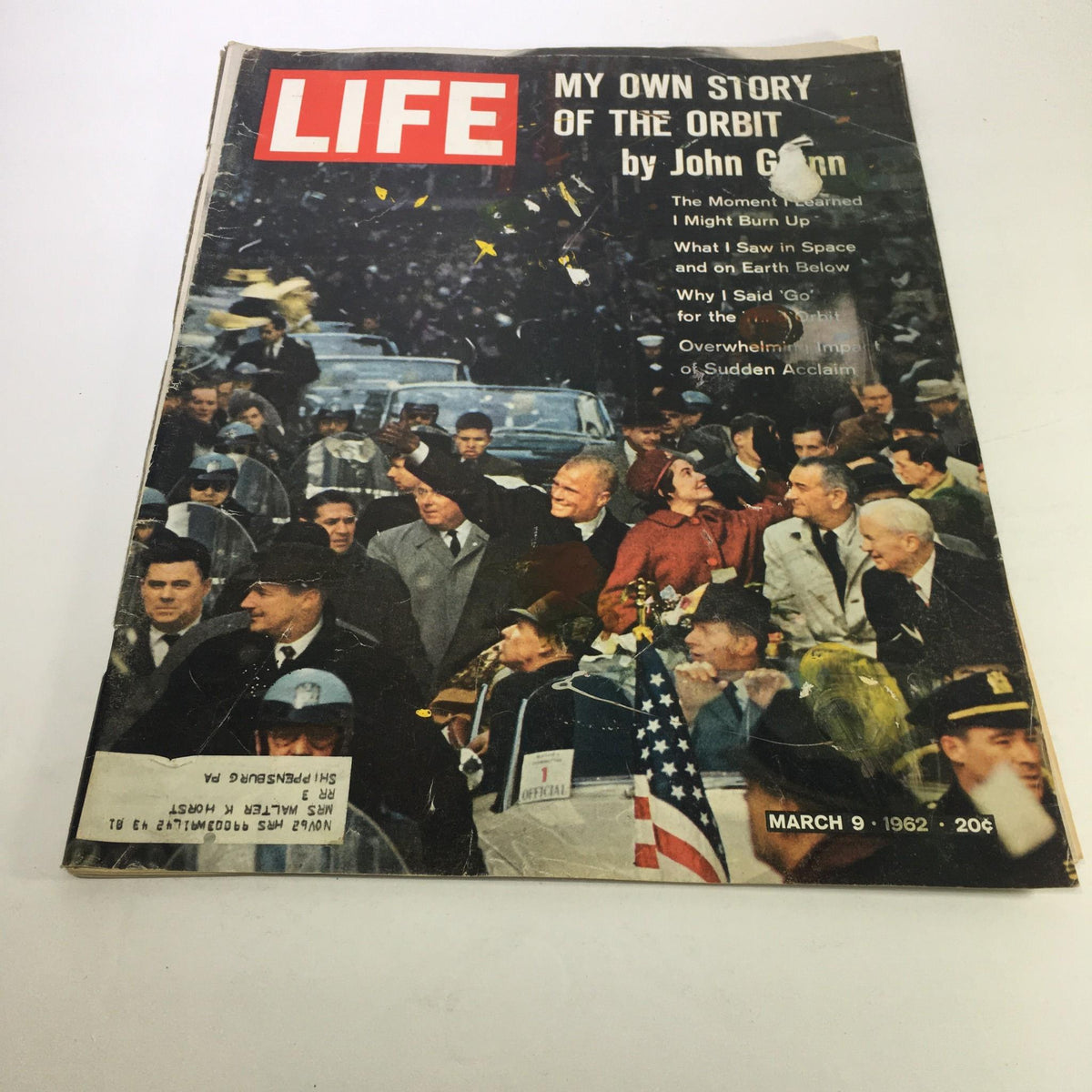 Cover of Life Magazine dated March 9, 1962, featuring the title 'My Own Story of the Orbit' by John Glenn, showcasing a historic moment in space exploration with a crowd celebrating around cars.