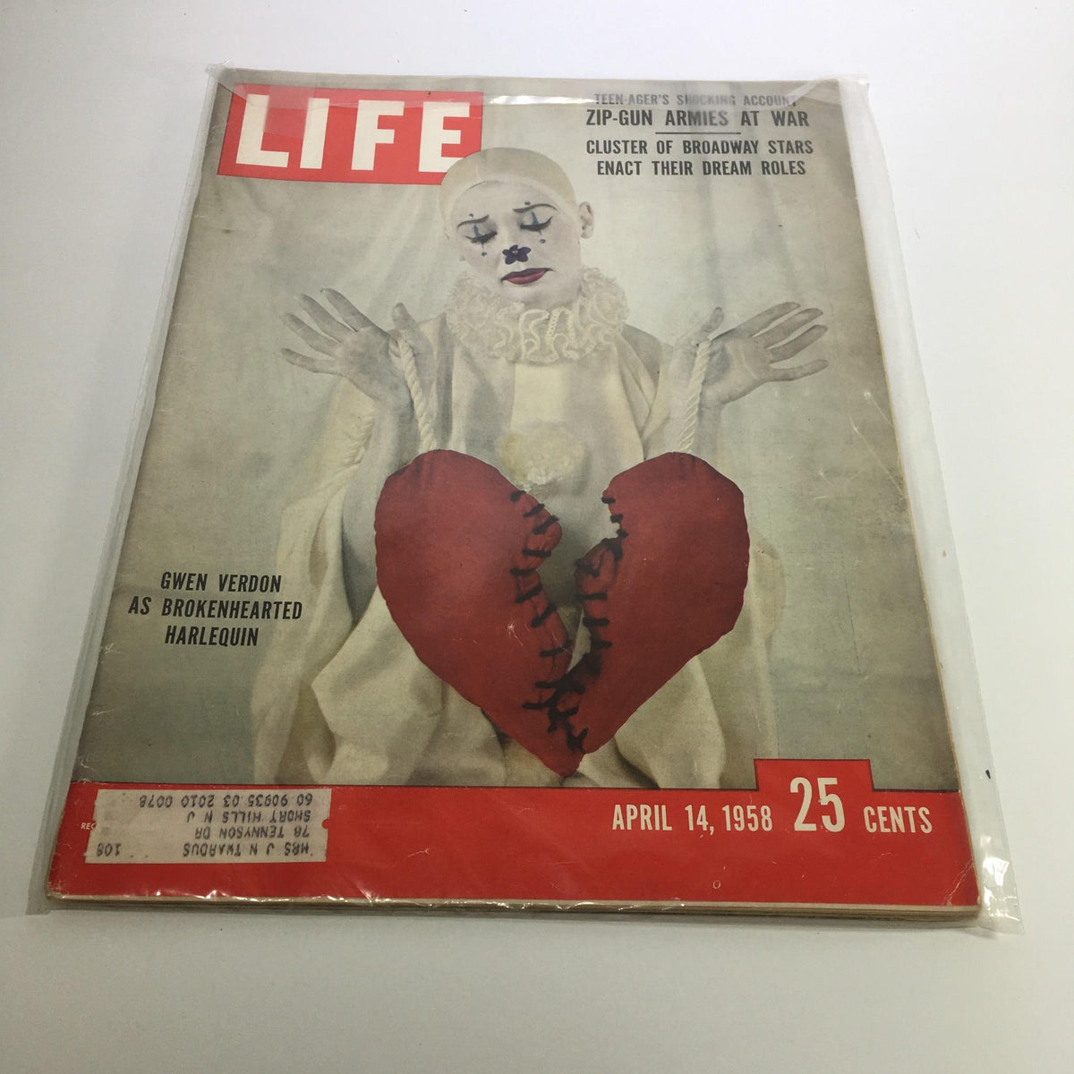 Life Magazine cover from April 14, 1958, featuring Gwen Verdon as Brokenhearted Harlequin, showcasing a vintage portrayal of theatrical artistry with a striking design of a clown holding a large broken heart.
