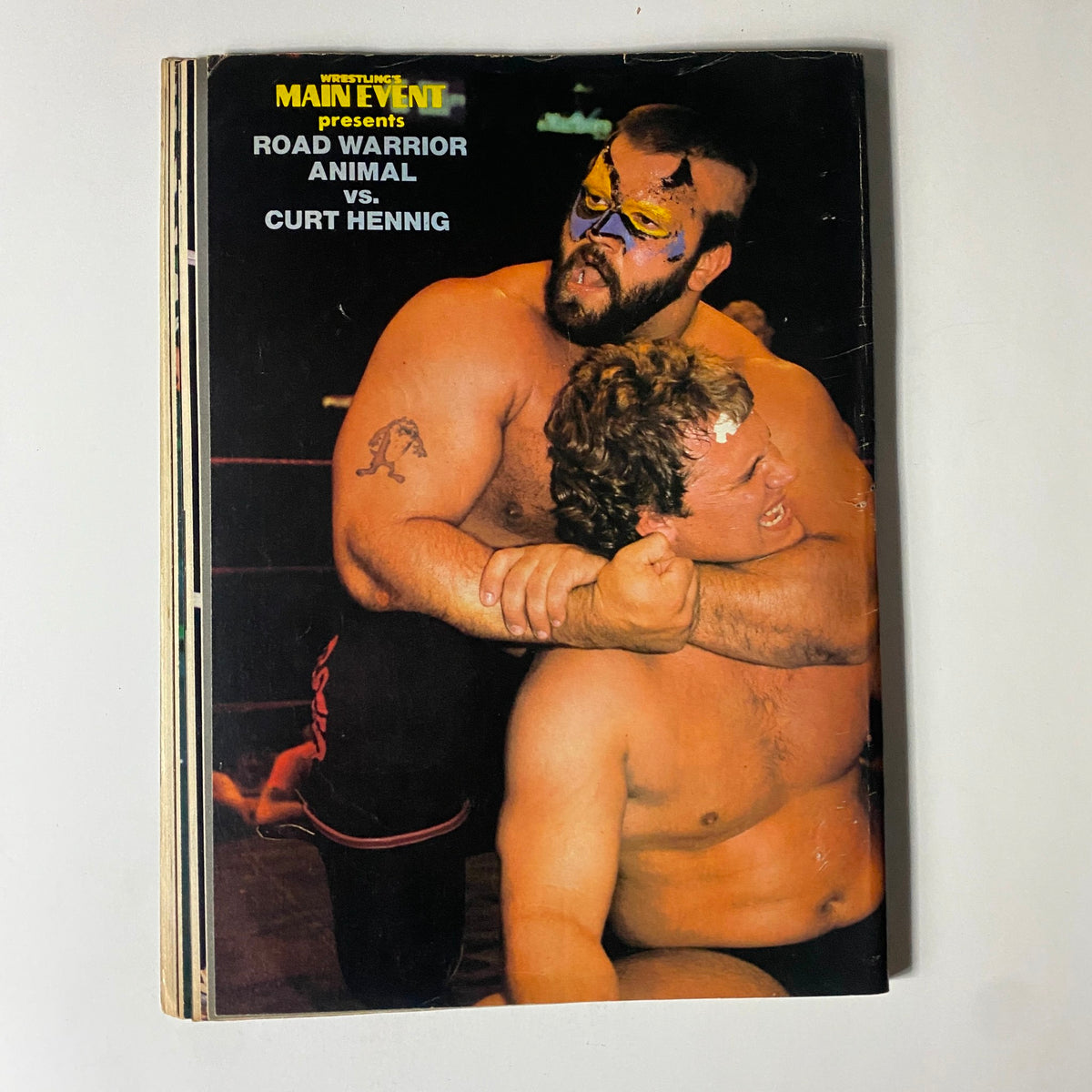 Back cover of Wrestling's Main Event Magazine September 1985 featuring a wrestling match between Road Warrior Animal and Curt Hennig.