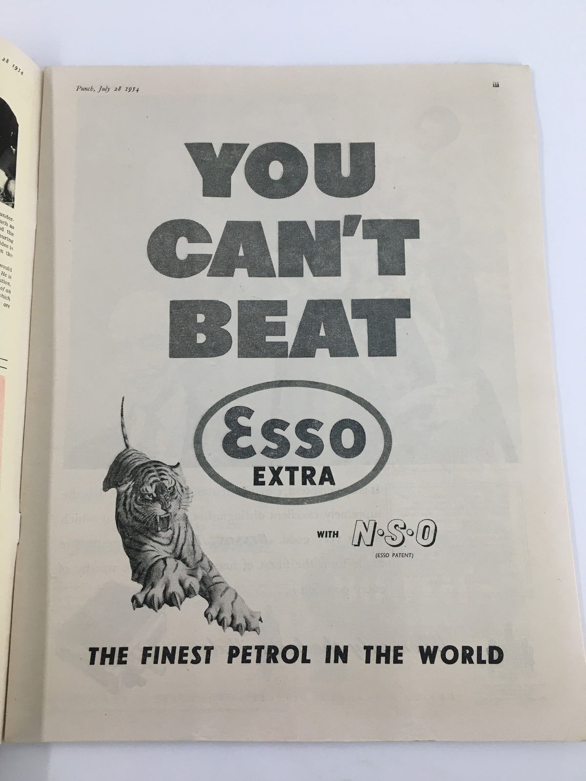 Advertisement page from Punch Magazine, July 28, 1954, showcasing Esso Extra petrol with a striking image of a tiger, emphasizing the quality and branding of fuel during the 1950s.