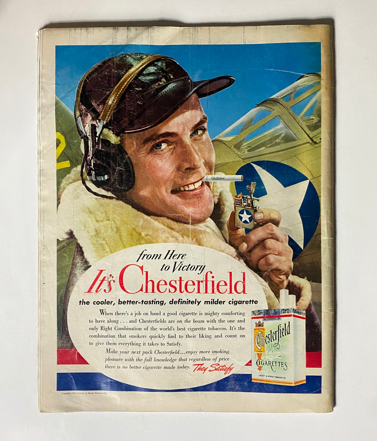 Vintage 1942 Look Magazine cover featuring an Apprentice Seaman, showcasing wartime atmosphere, with advertisement for Chesterfield cigarettes in the background.