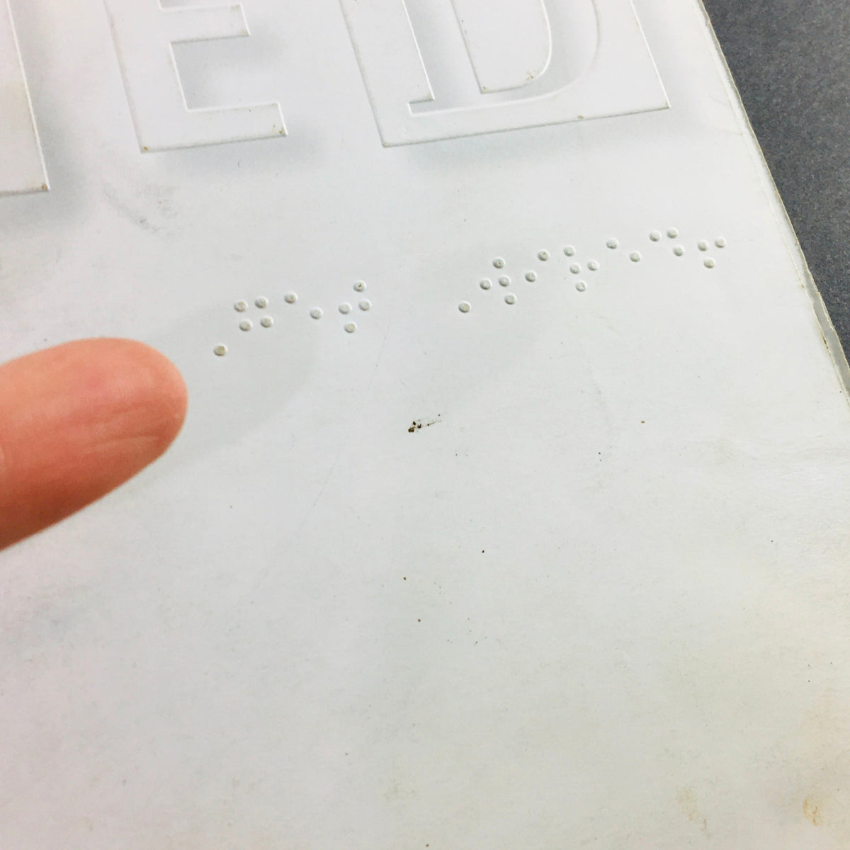 Close-up view of the back cover of Wired Magazine January 1995 Vol 3 #1 showcasing embossed letters and braille details.