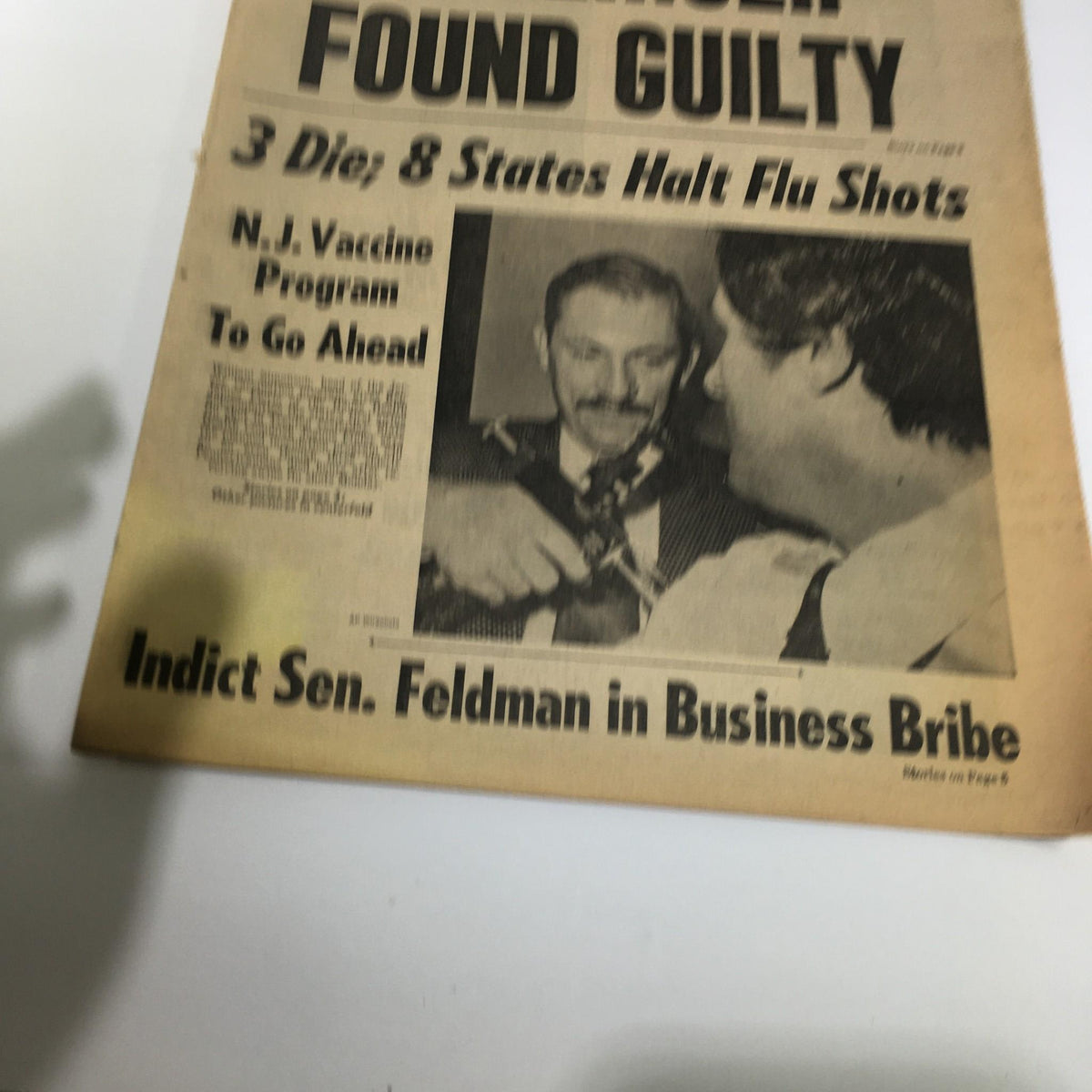 NY Daily News headline from October 13, 1976, featuring news on 3 Die, 8 States Halt Flu Shots, and an image related to the N.J. Vaccine program. This historic newspaper showcases significant events of the time.