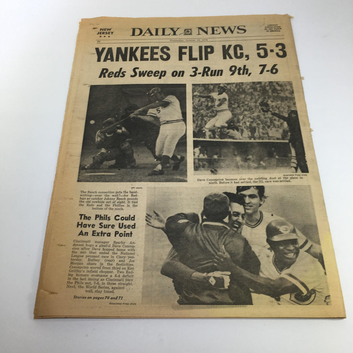 NY Daily News from October 13, 1976, detailing the Yankees' victory against KC with a score of 5-3, accompanied by images of the game highlights. A collectible piece reflecting sports history.