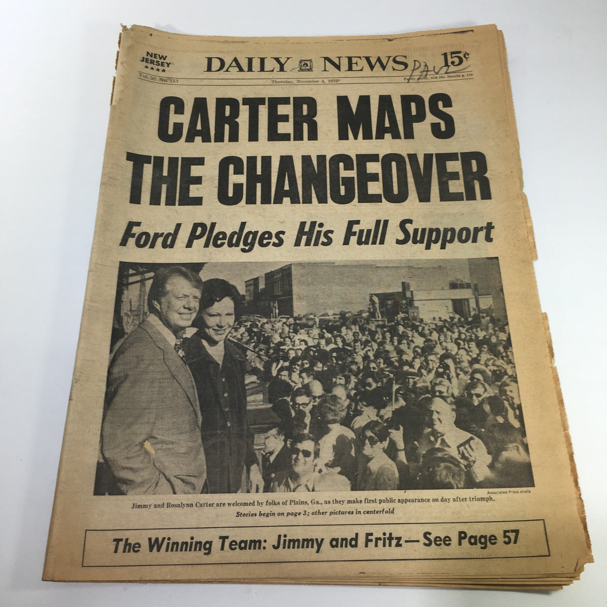 NY Daily News headline from November 4, 1976, featuring the title 'Carter Maps The Changeover Ford Pledges His Full Support', depicting Jimmy Carter and his wife, Rosalynn, at a public event.
