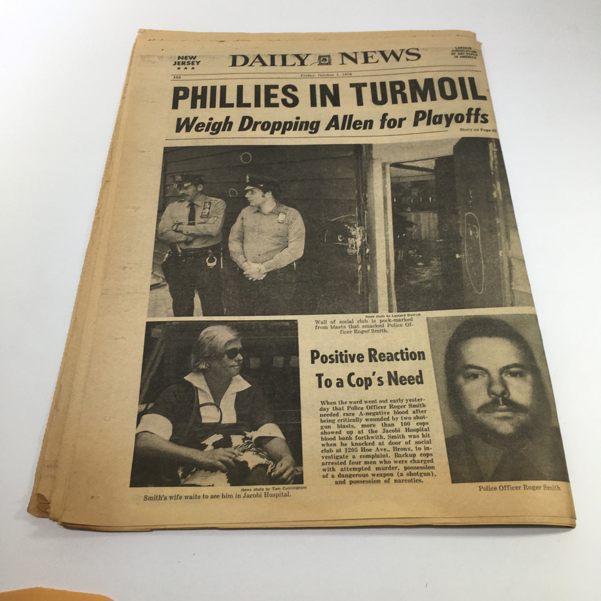 NY Daily News article title "Phillies in Turmoil" covering the Philadelphia Phillies' playoff situation, featuring images related to local events. Highlights include the mention of police officer's reaction in the context.