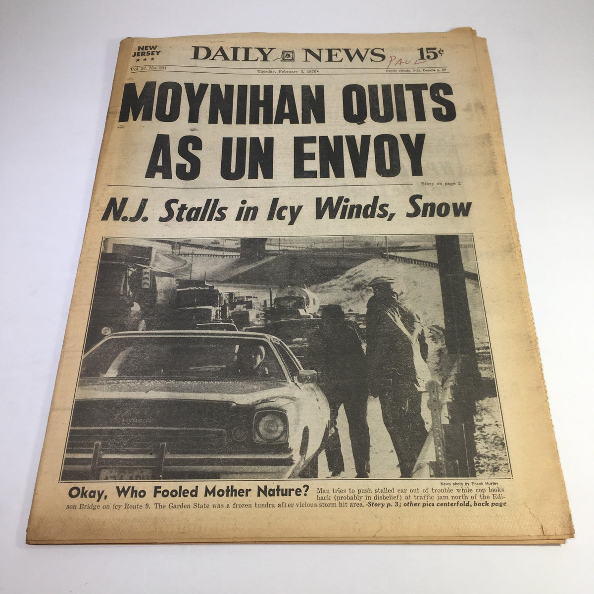 NY Daily News headline from 2/3/1976, featuring the announcement 'Moynihan Quits As UN Envoy' alongside a news piece about New Jersey weather conditions, with a vintage car in the foreground.