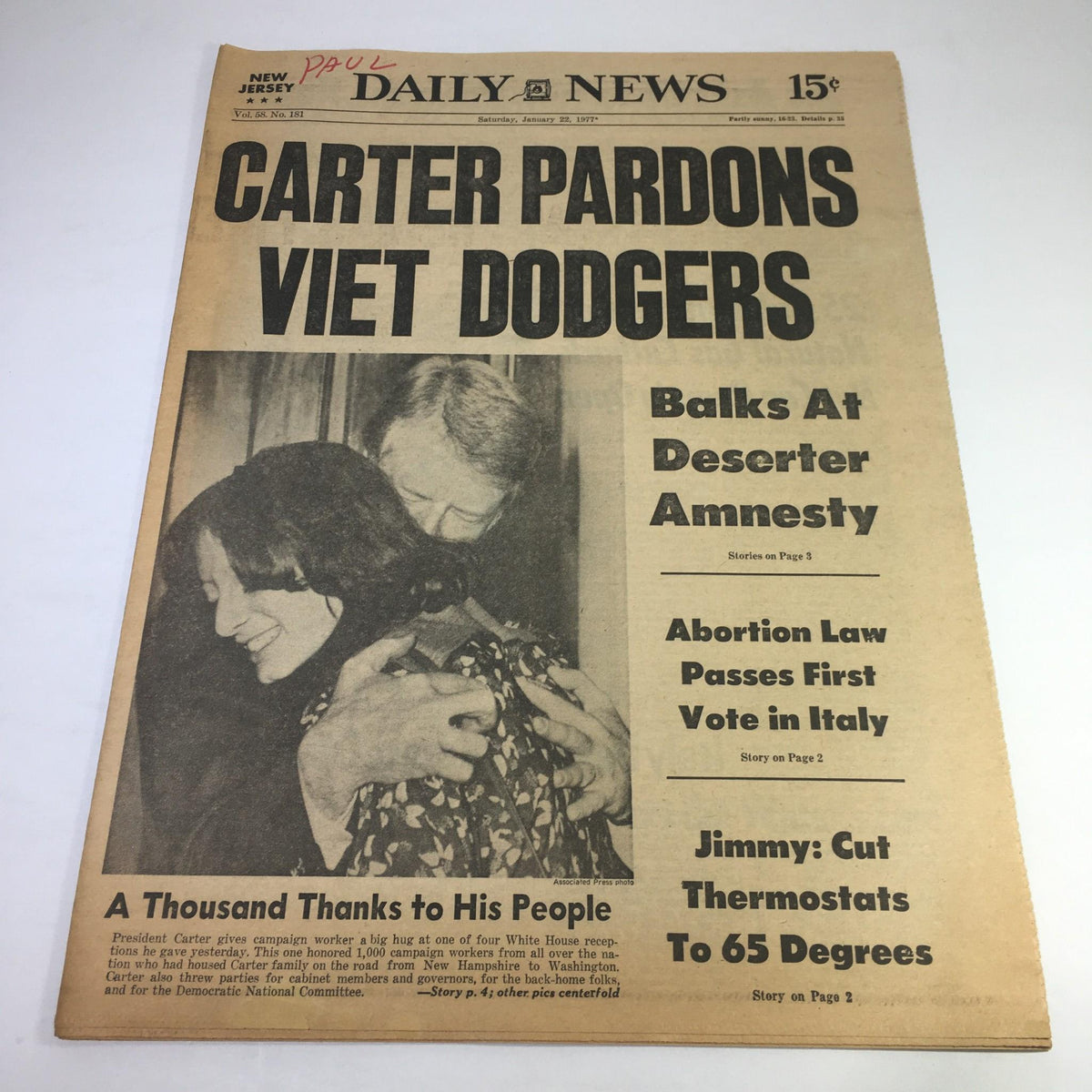New York Daily News cover from January 22, 1977 featuring the headline 'Carter Pardons Viet Dodgers' with a supporting image showing a jubilant couple celebrating, highlighting the theme of amnesty and gratitude.