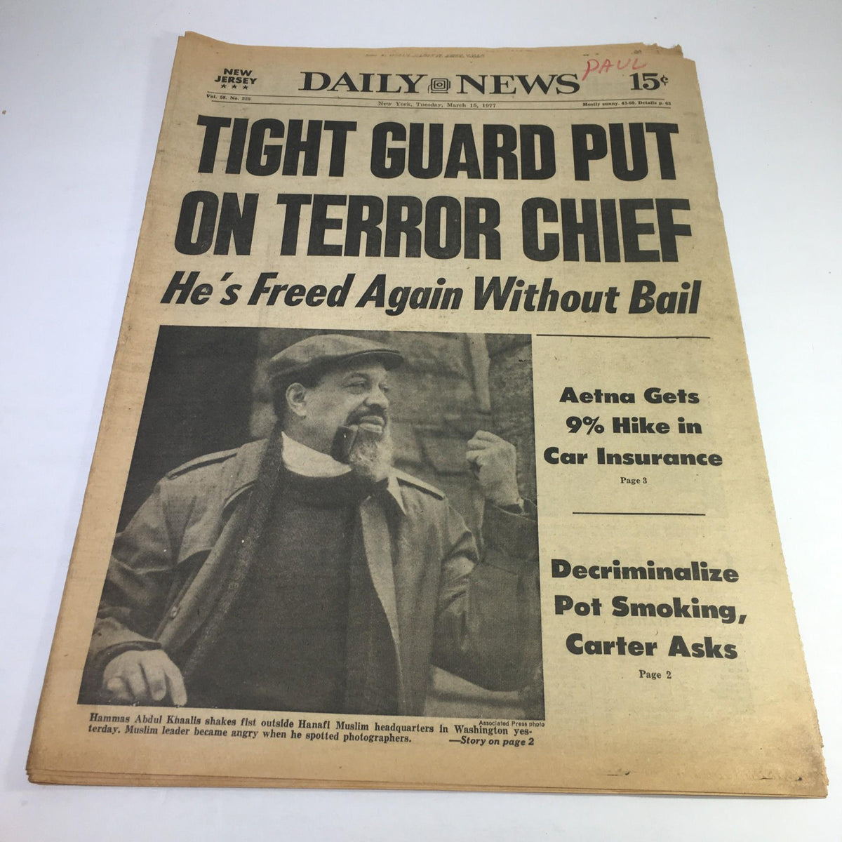 NY Daily News from March 15, 1977 featuring the headline 'TIGHT GUARD PUT ON TERROR CHIEF; He's Freed Again Without Bail'. The front page includes a photo of Hammas Abdul Khaalis and addresses issues of security and terrorism.