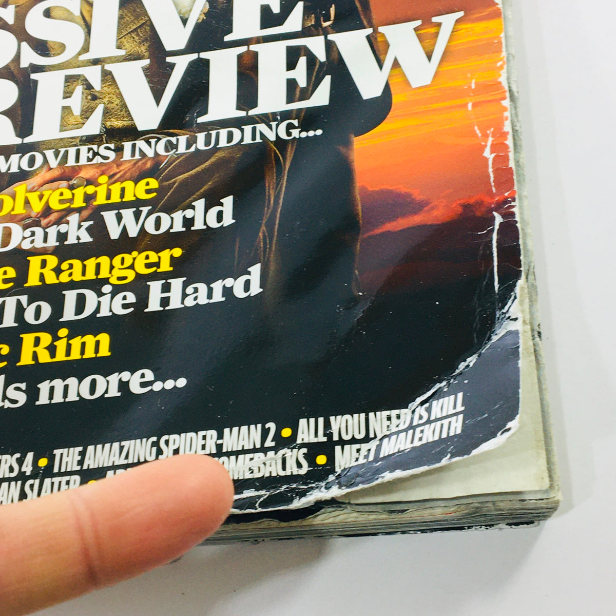Close-up of the corner of Total Film Magazine February 2013 #202, displaying wear and tear, including a torn edge and details on featured movies.