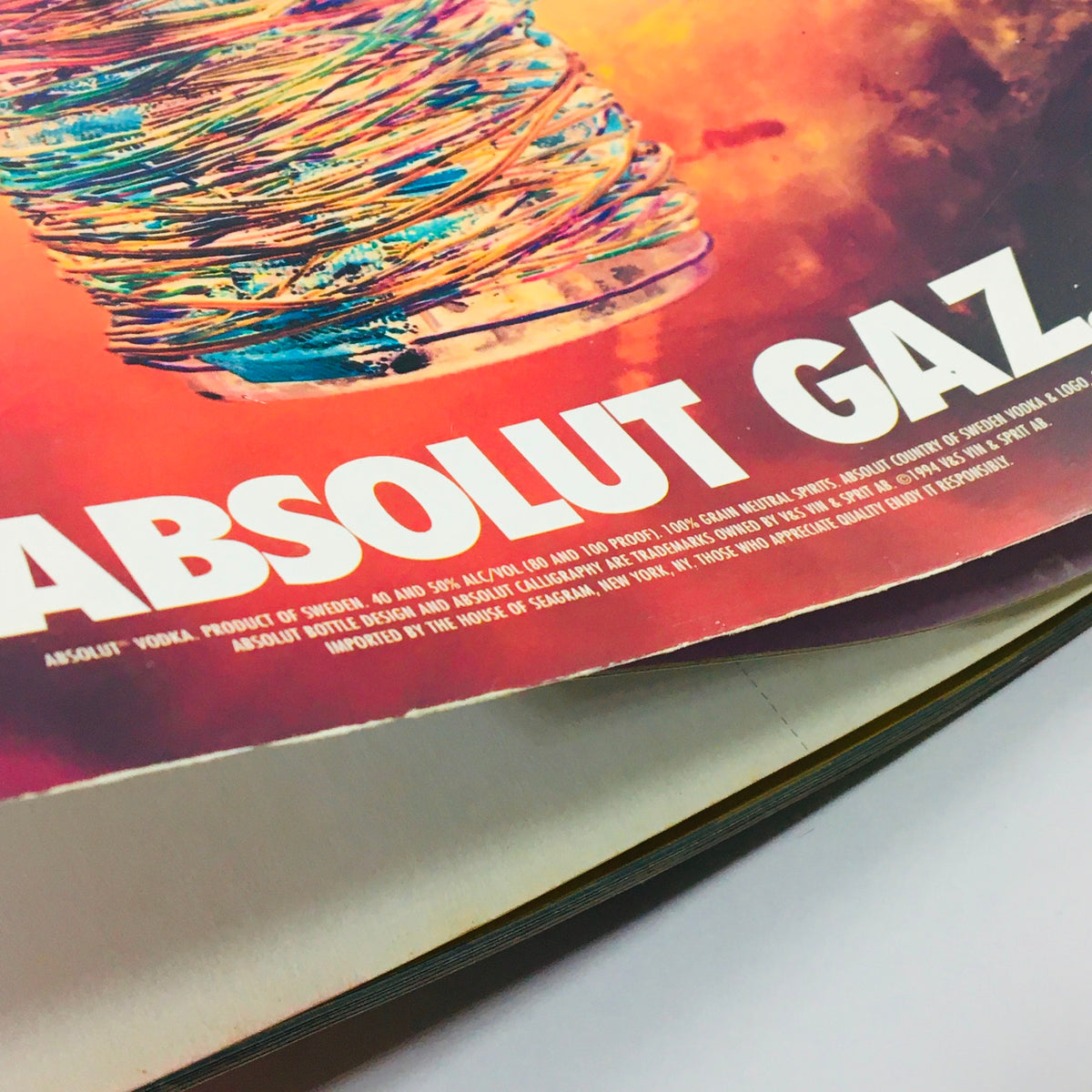 Close-up of an advertisement from Wired Magazine February 1995 featuring a colorful Absolut Gaz vodka bottle, highlighting the magazine's unique graphical style.