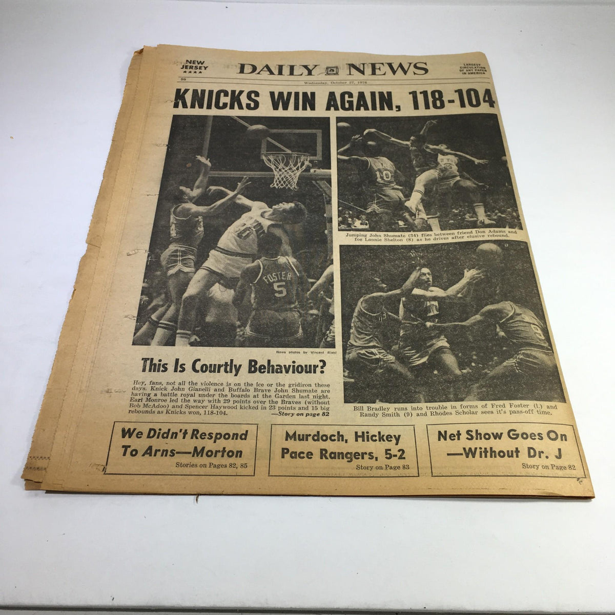 NY Daily News front page titled 'Knicks Win Again, 118-104', showcasing highlights from a basketball game. The page features action shots of players and commentary on the team's performance.