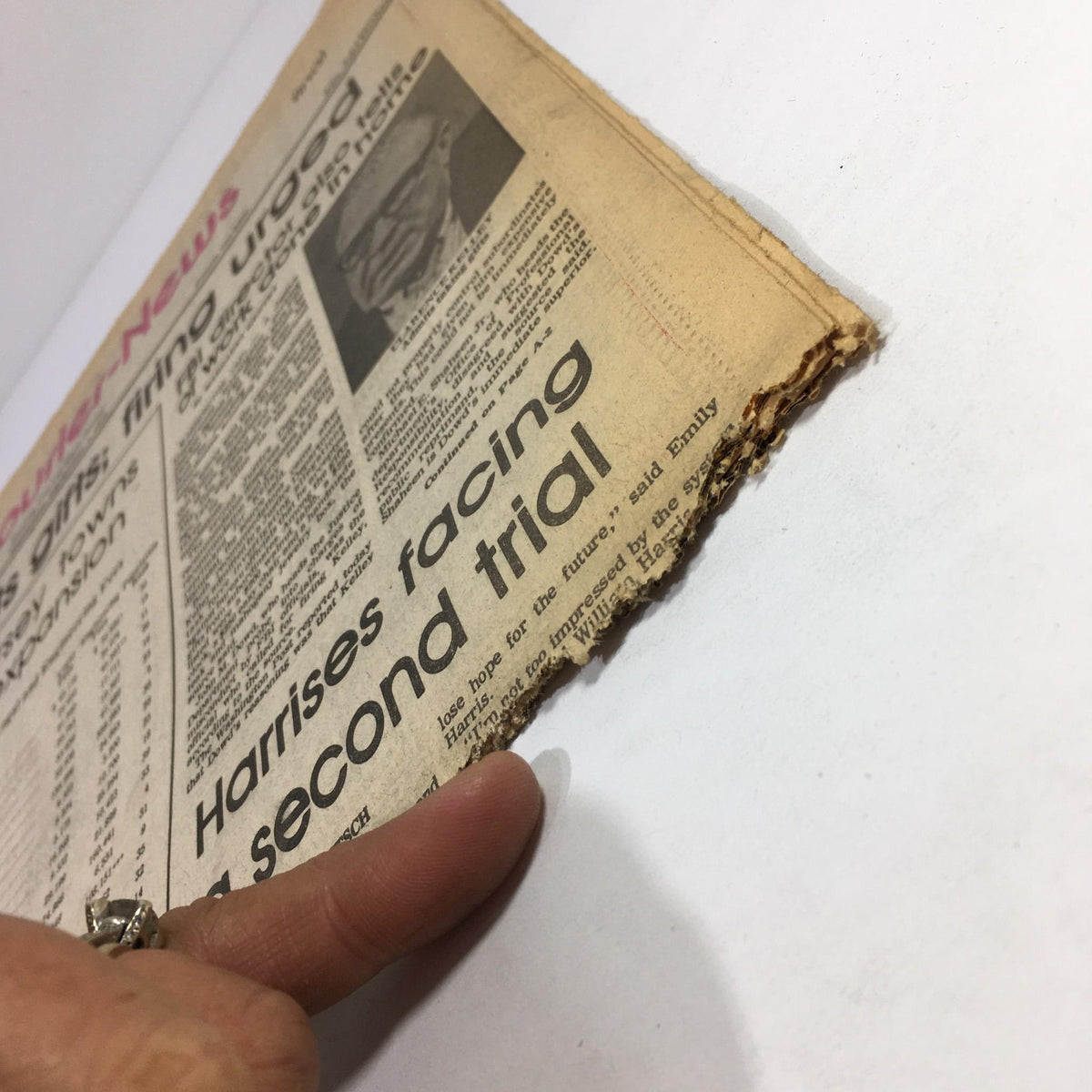 Close-up view of the September 1, 1976, Courier News, highlighting the damaged edge of the paper while addressing the topic of Clarence Kelly admitting to taking gifts.
