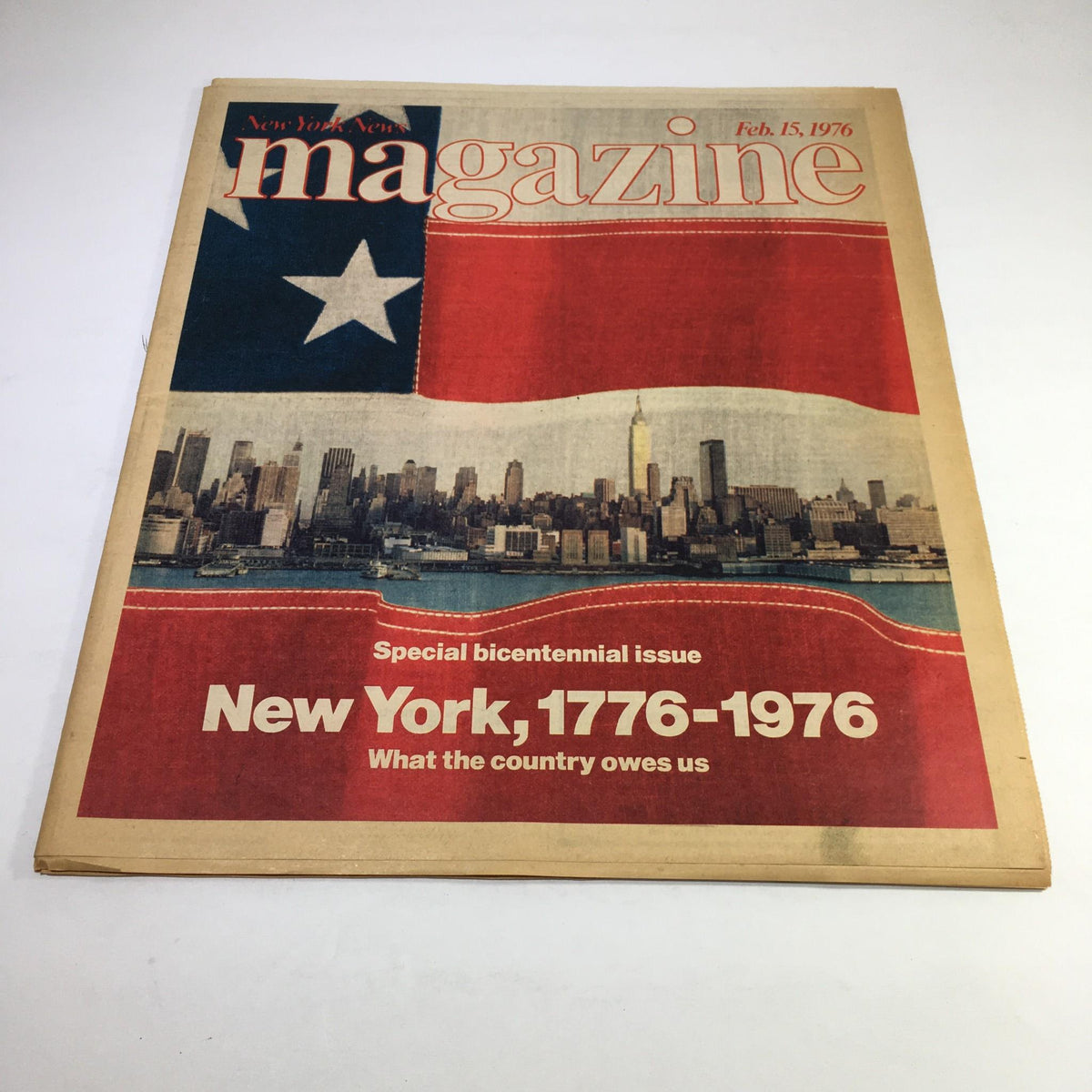 Cover of New York News Magazine dated Feb 15, 1976, featuring a special bicentennial issue titled 'New York, 1776-1976', with a backdrop of the New York City skyline and an American flag design.