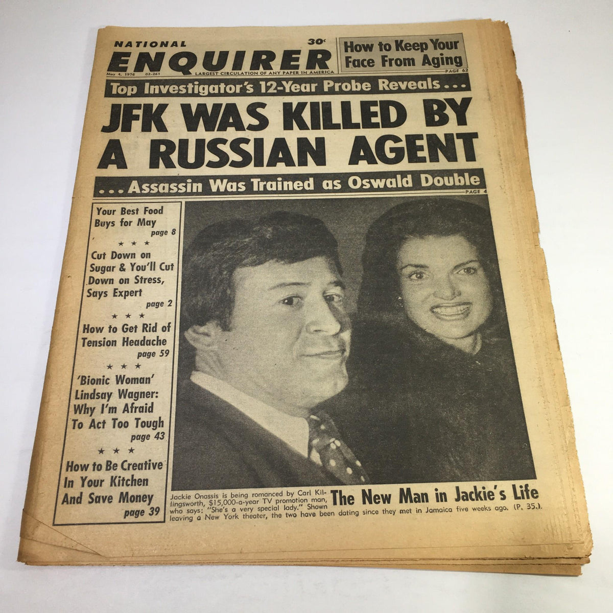 Historic National Enquirer newspaper headline from May 4, 1976, stating 'JFK Was Killed by a Russian Agent'. Image features a photo of Jackie Onassis alongside the article about the assassination claims.