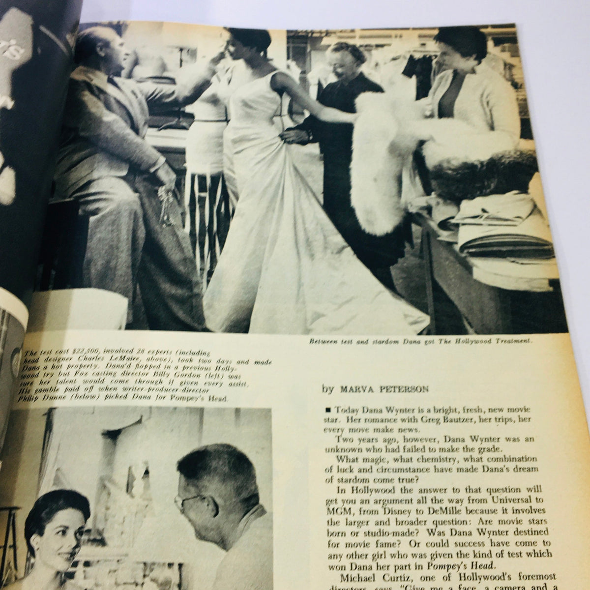 Behind-the-scenes moment featuring actress Dana Wynter during a fitting for her role, depicted in the May 1956 issue of Modern Screen Magazine.