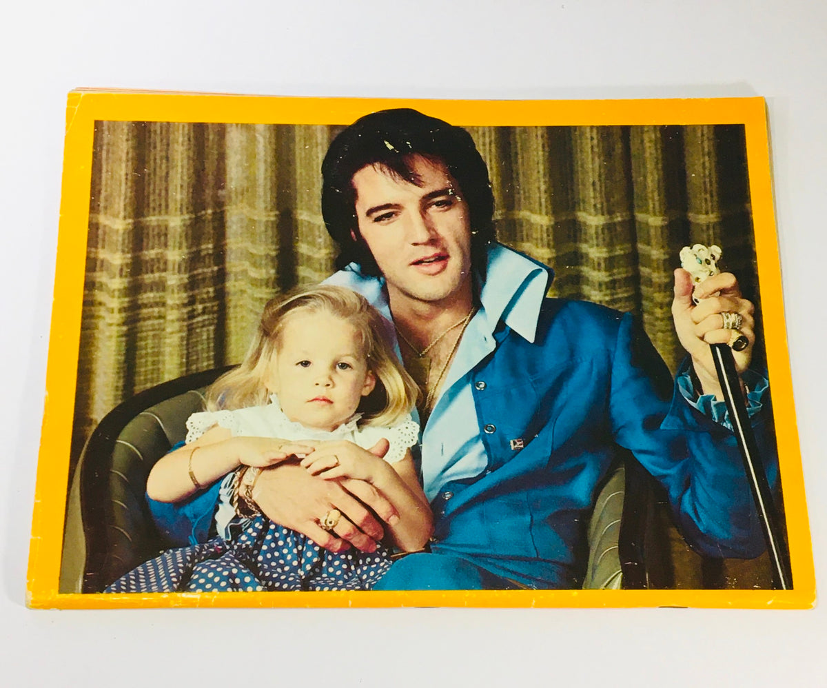 Image of Elvis Presley holding a child, featured in the Platinum Presents 1979 #6 Elvis Presley Diary, showcasing a personal moment with a heartfelt connection.