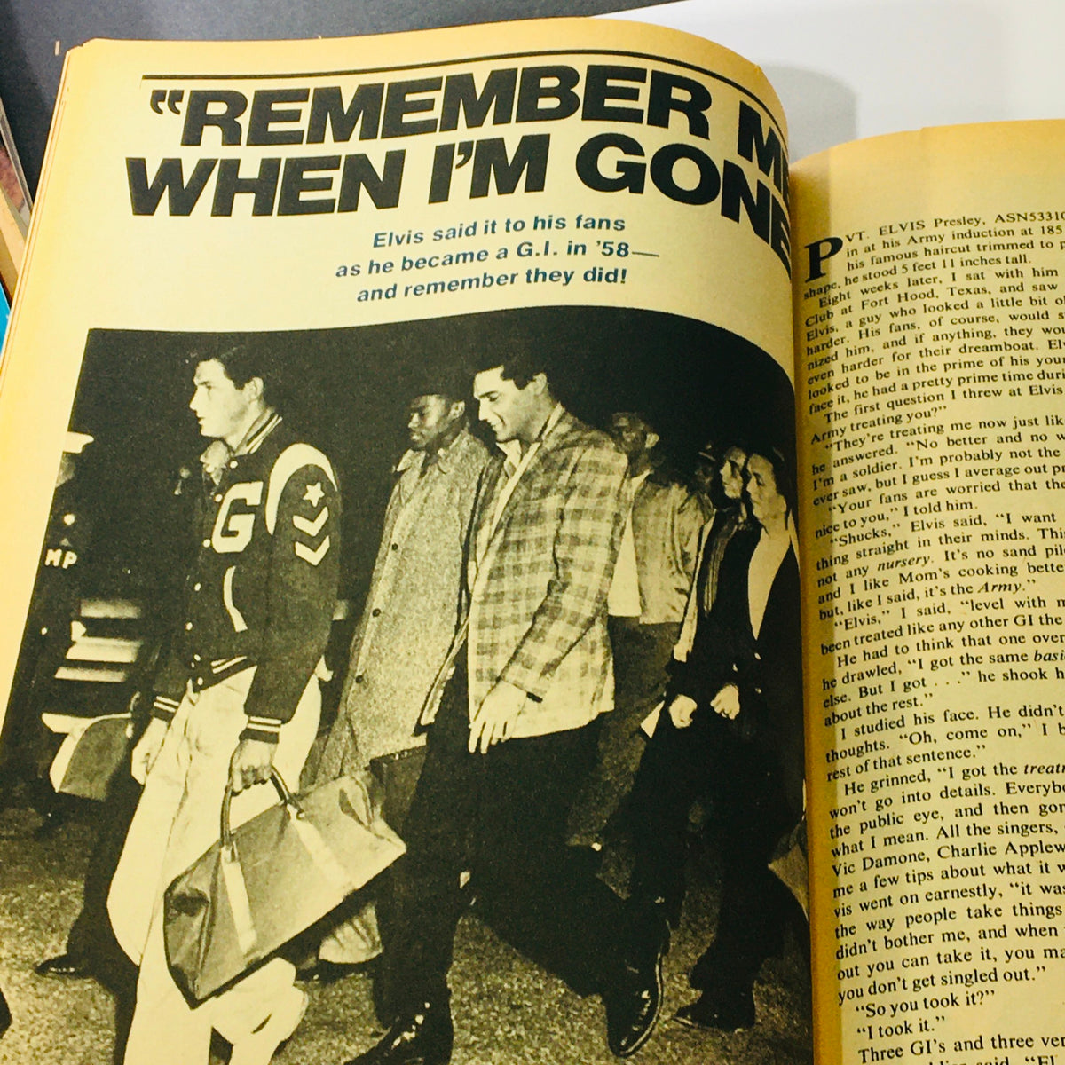 Photograph from the VTG 1977 Elvis Aron Presley A Photoplay Tribute Special Collector's Edition capturing Elvis Presley walking as a G.I. with fans, reflecting on his iconic status.