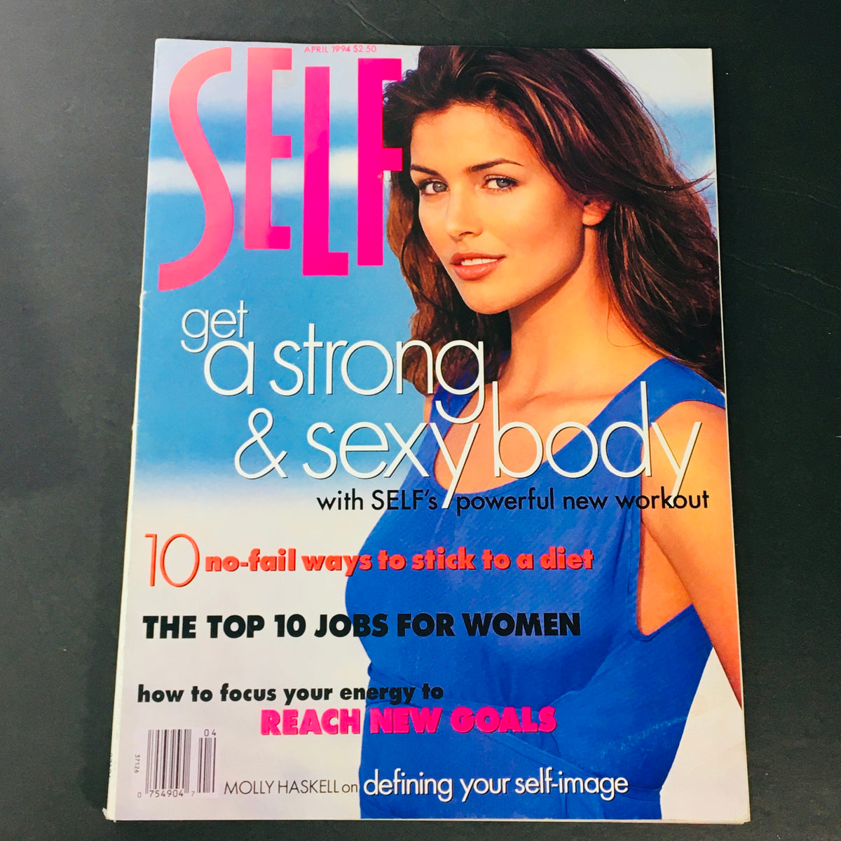 Cover of Self Magazine, April 1994, featuring Molly Haskell's article on defining your self-image, with a focus on body positivity, and tips for women, showcasing a vibrant blue dress and a beautiful model.