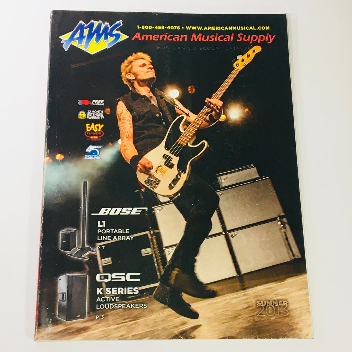 Cover page of American Musical Supply Catalog Summer 2013 featuring the Bose L1 Portable Line Array and QSC K Series active loudspeakers with a musician playing a bass guitar.