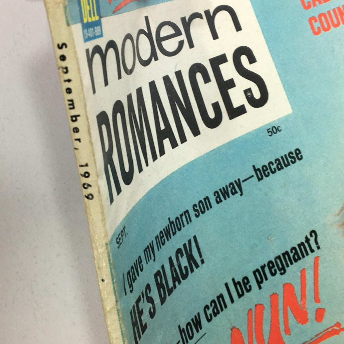 Side view of 'VTG Modern Romances September 1969' magazine, displaying the title and the intriguing headline 'I gave my newborn son away—because HE'S BLACK!'