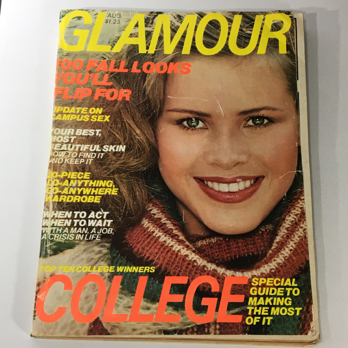 Vintage Glamour Magazine August 1977 cover featuring a model with styled hair, promoting '100 Fall Looks You'll Flip For' and showcasing the magazine's bold yellow and red typography.