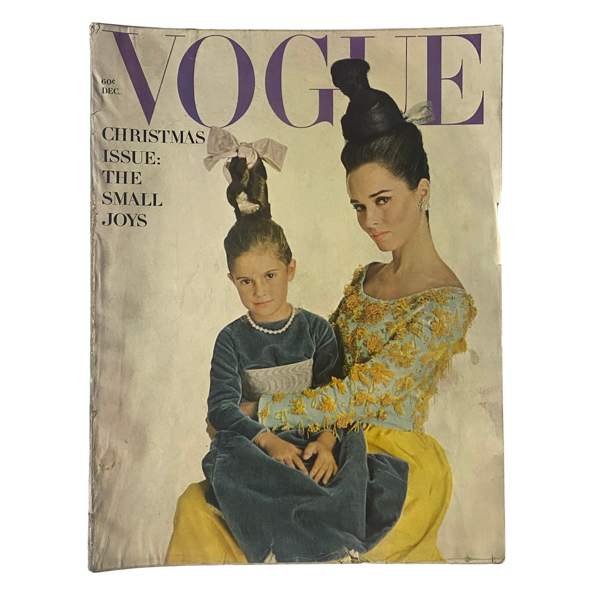 Vogue Magazine December 1962 cover featuring model Sondra Peterson and a child, styled in festive attire for the Christmas issue, showcasing mid-century fashion elegance.