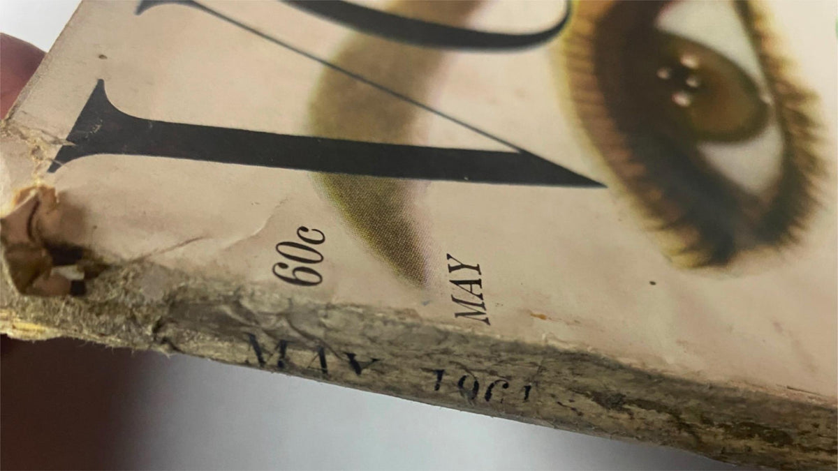 Close-up of the spine of Vogue Magazine May 1961 Sophia Loren & Anne St. Marie Cover Collage, displaying age and wear indicative of its vintage status.